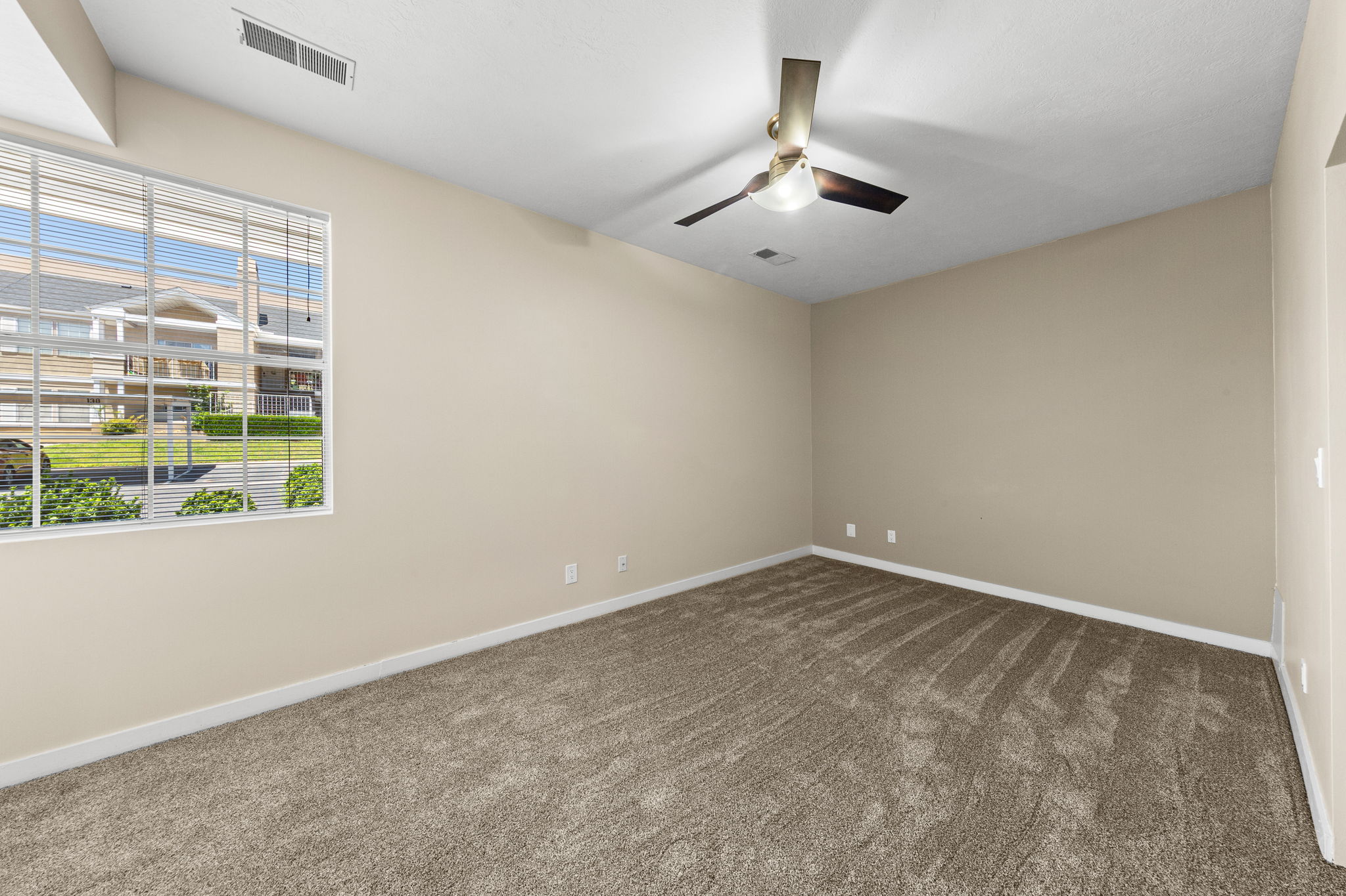 Neutral-toned carpeting throughout the room