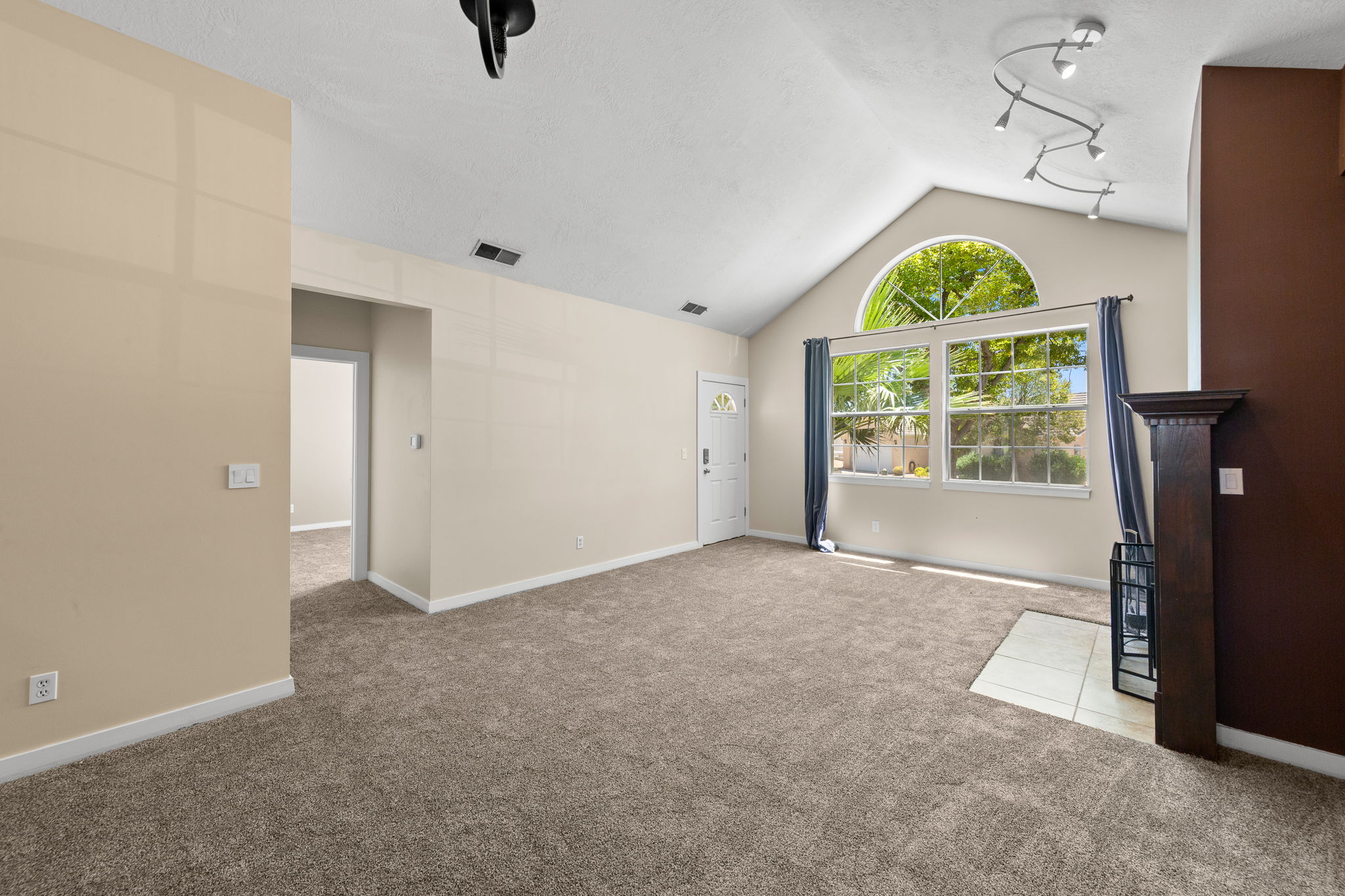 Vaulted ceilings highlight a window with an arched transom