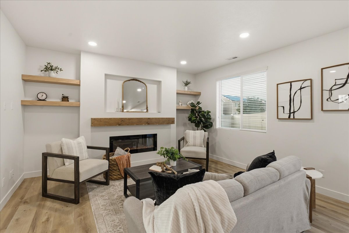 Living area featuring a contemporary linear fireplace with a substantial wood mantel, recessed lighting, and light wood-finish flooring