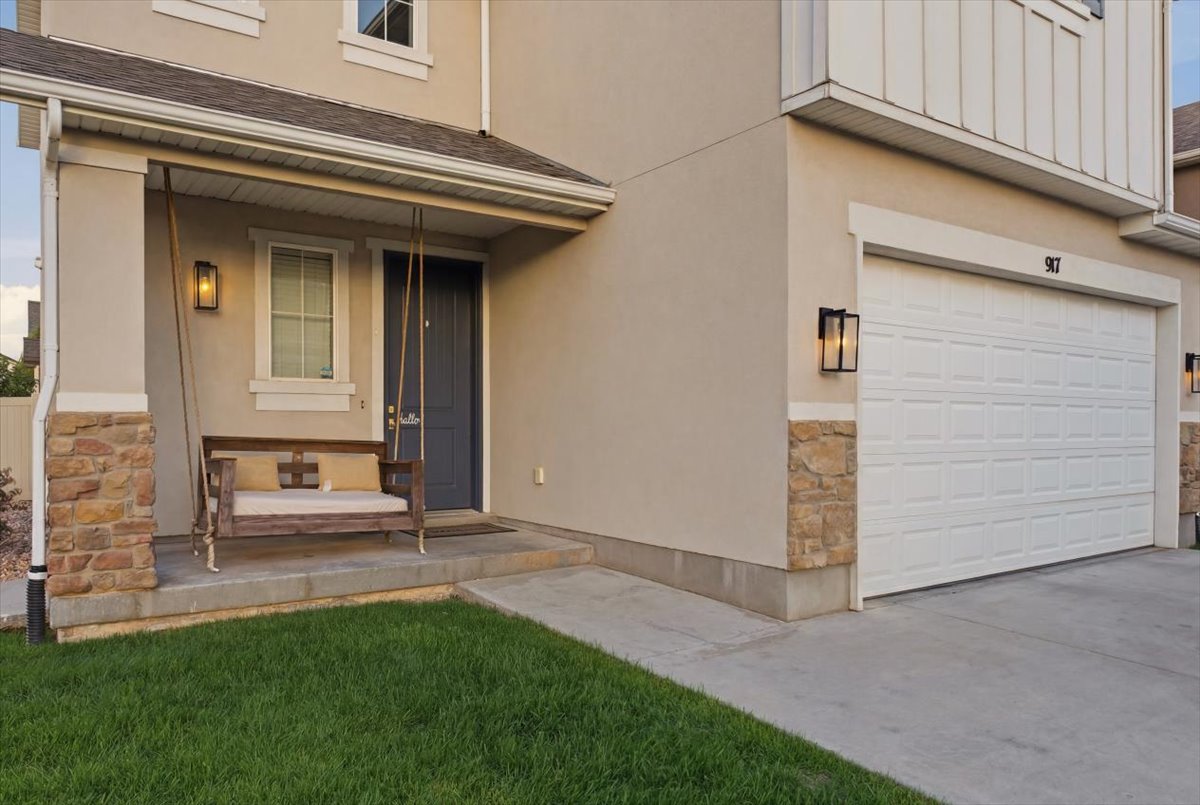 Exterior featuring stucco siding, stone accents, and a covered porch