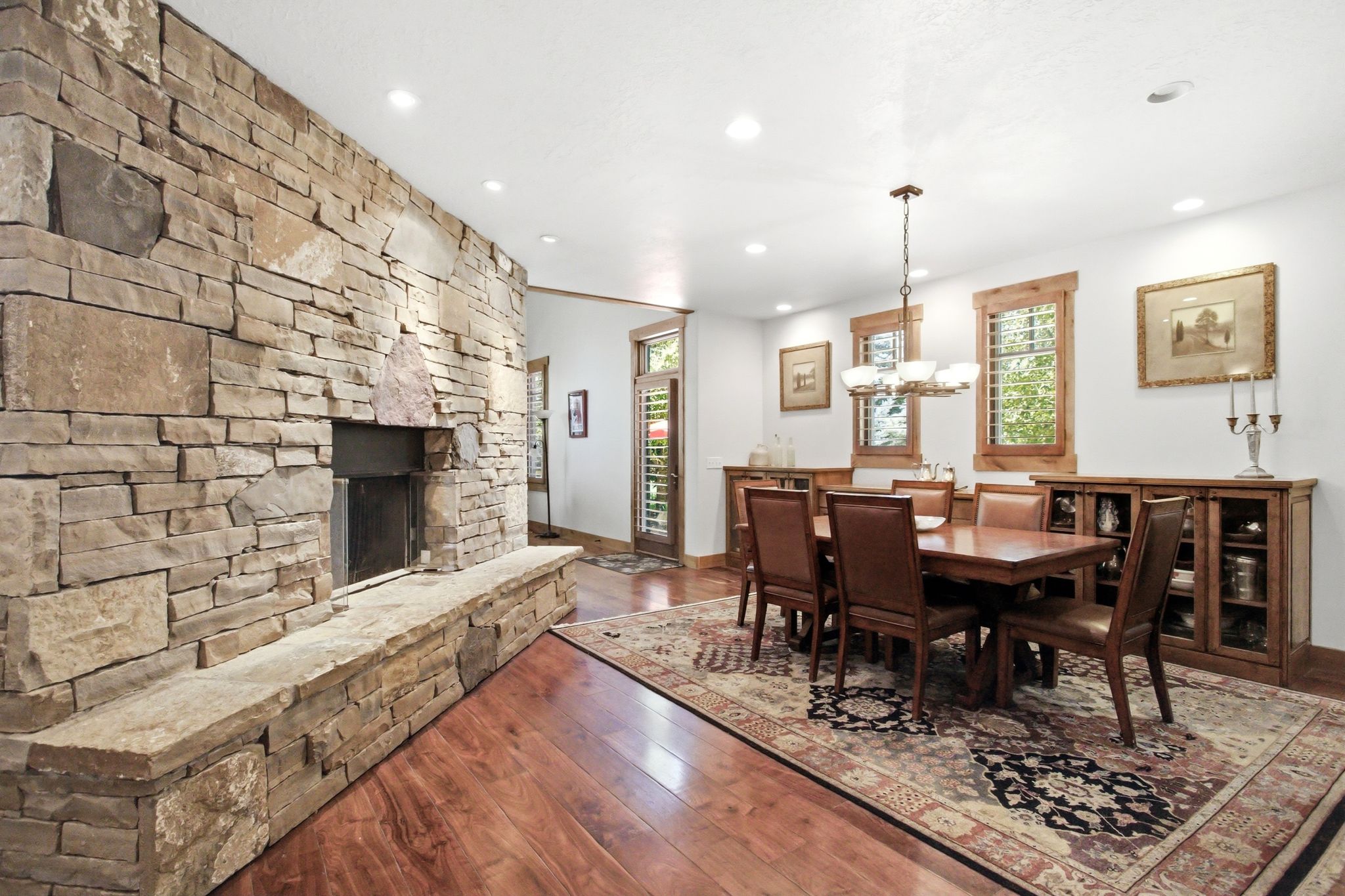 Expansive stone fireplace with a raised hearth