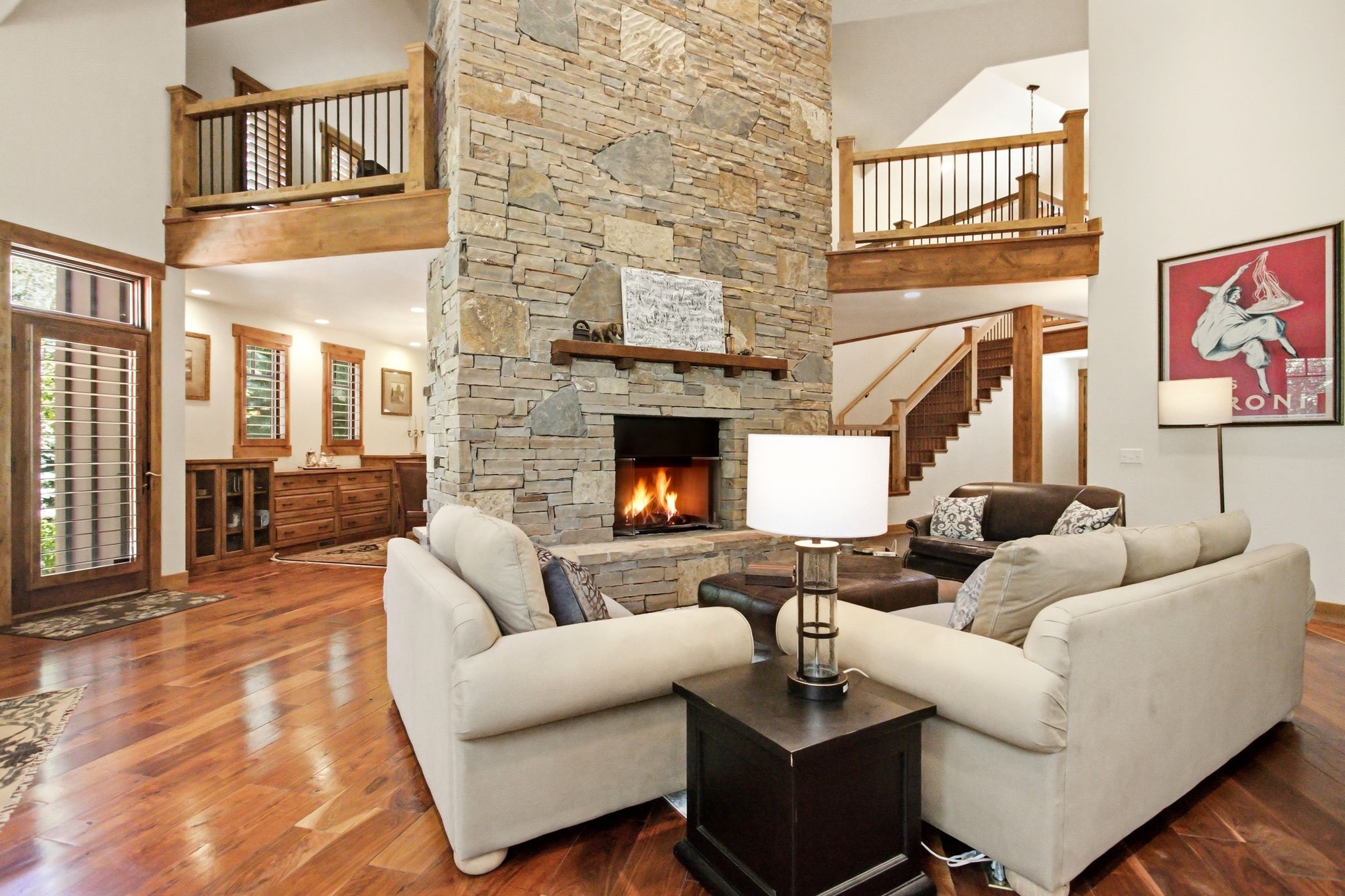 Two-story stone fireplace with wood mantel