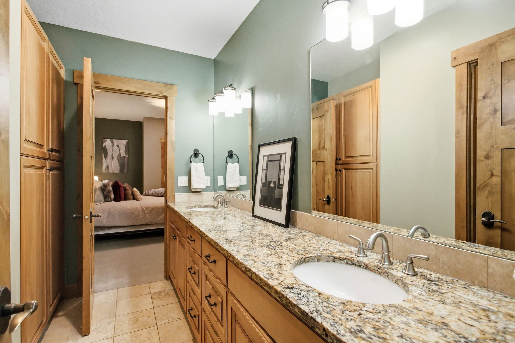 Dual vanity featuring an integrated sink, stone countertop, and brushed nickel fixtures