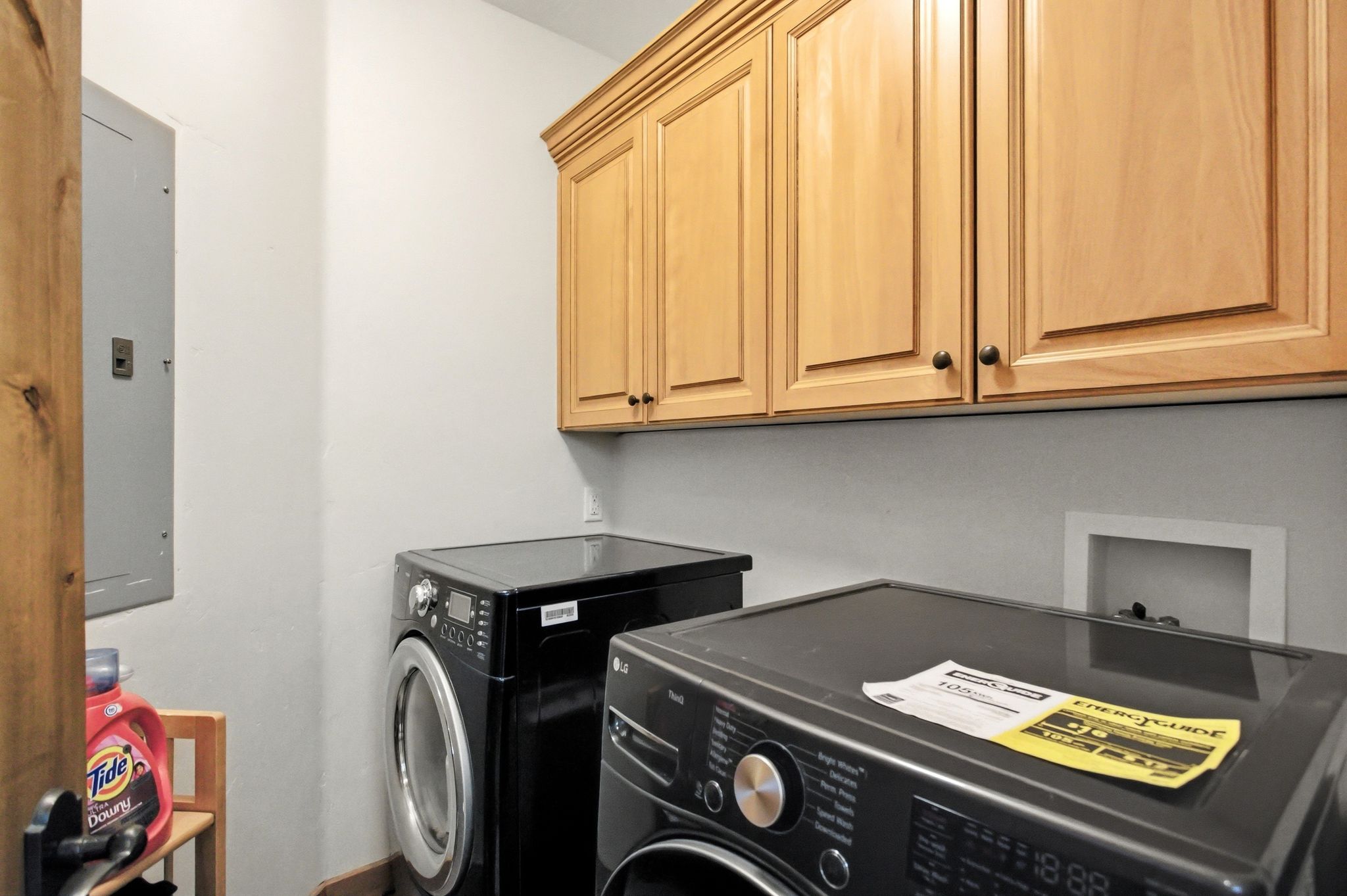 Light wood-finish cabinetry provides overhead storage