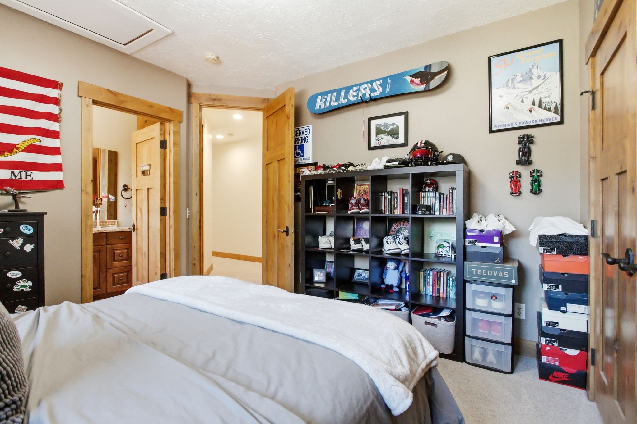 Bedroom featuring natural wood trim around doorways and a six-compartment built-in shelving unit