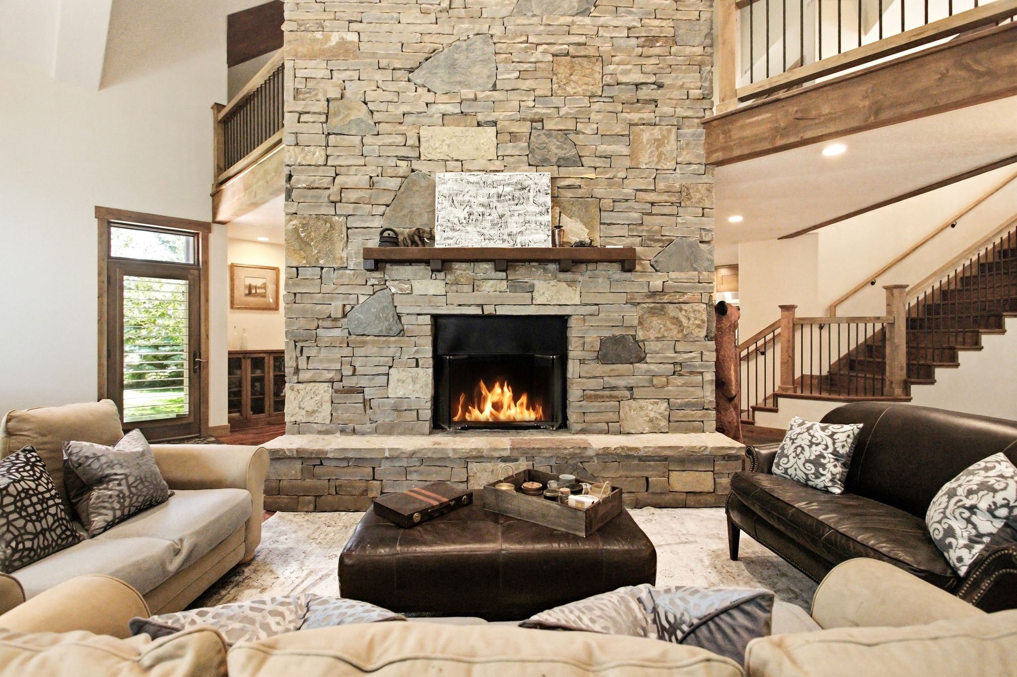 Stone-clad fireplace with a raised hearth and wood mantel