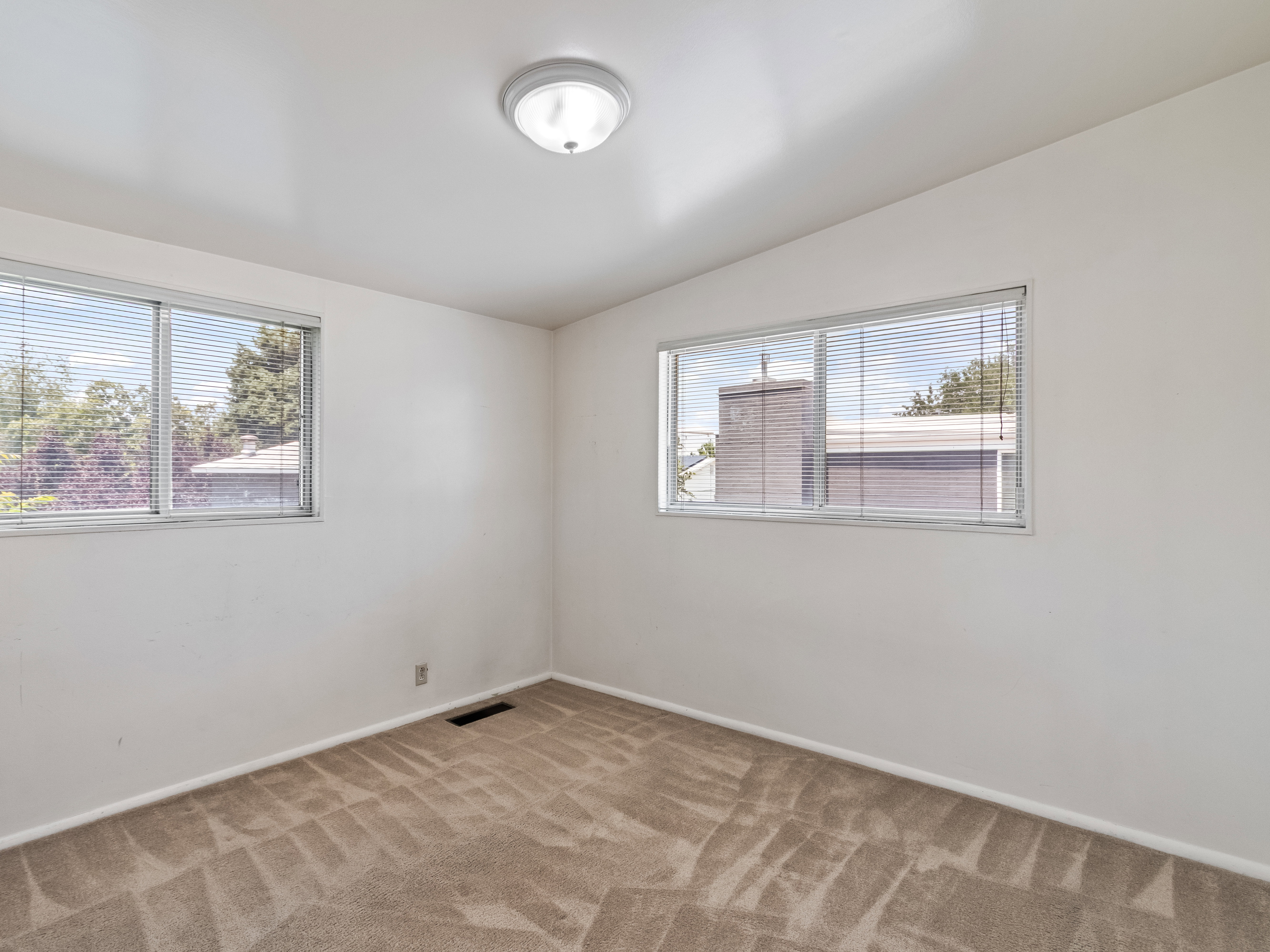 Neutral wall finishes with a flush-mount ceiling light