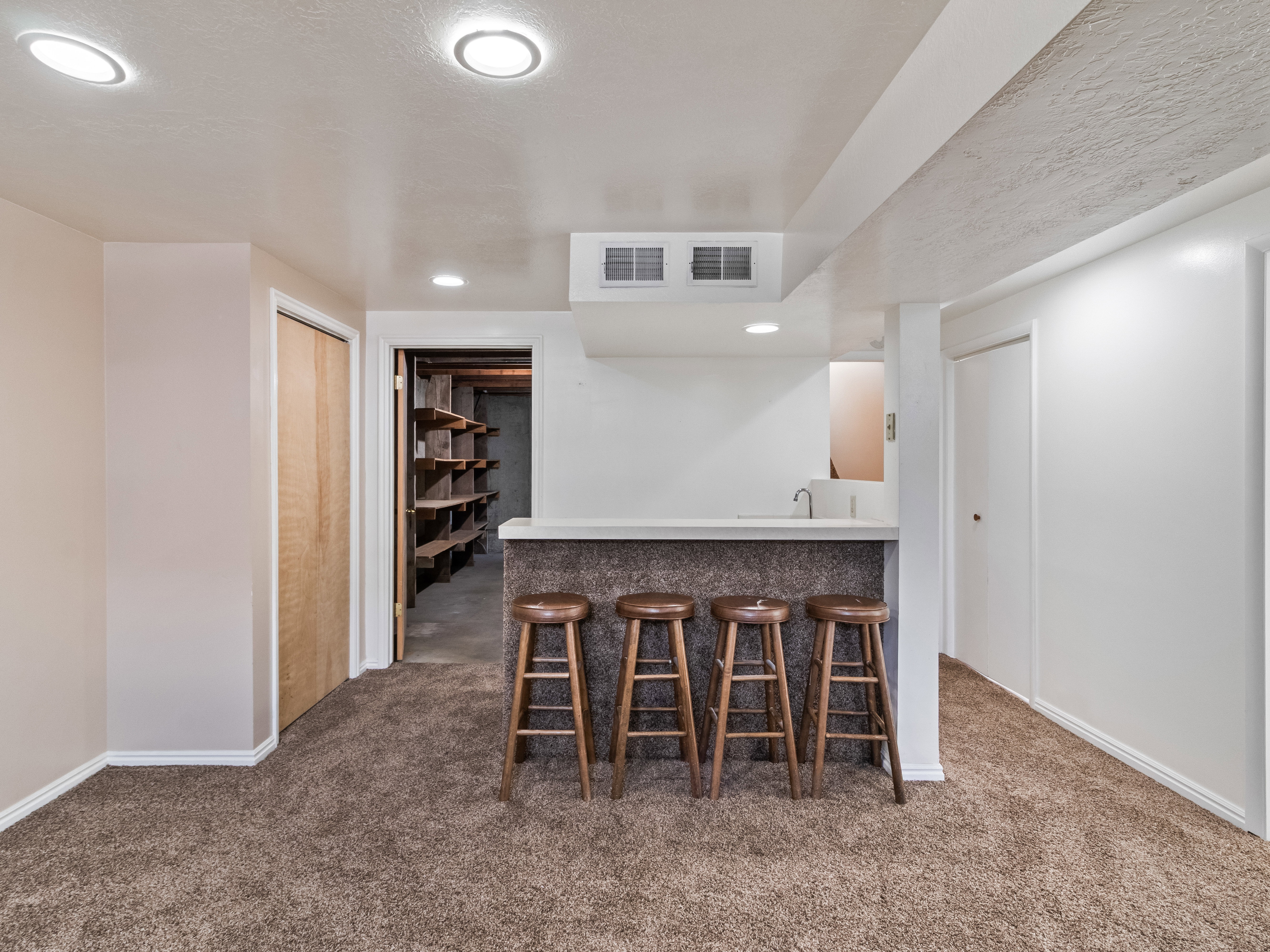 Built-in bar with a light-colored countertop and integrated sink