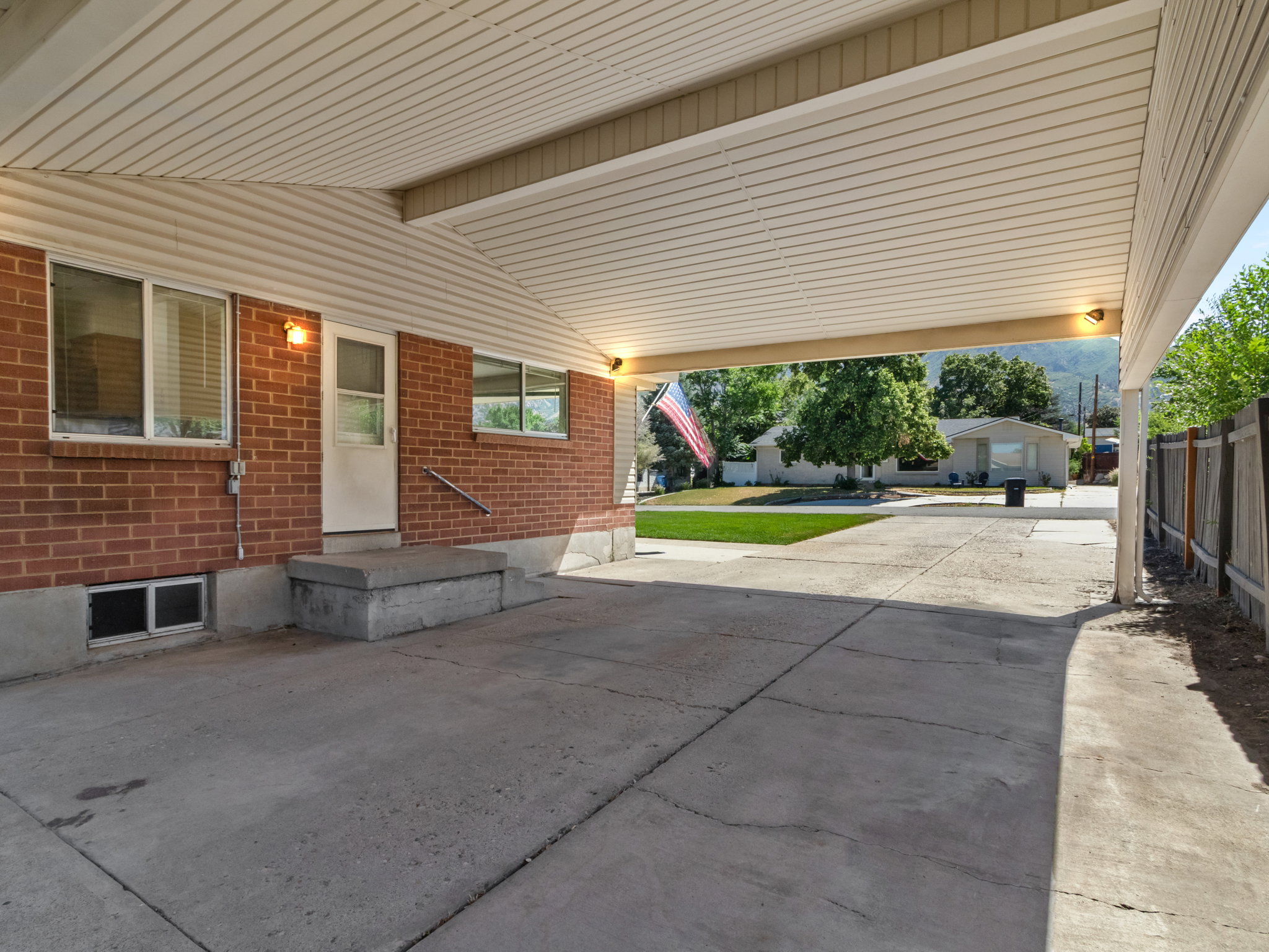 Covered carport with concrete flooring