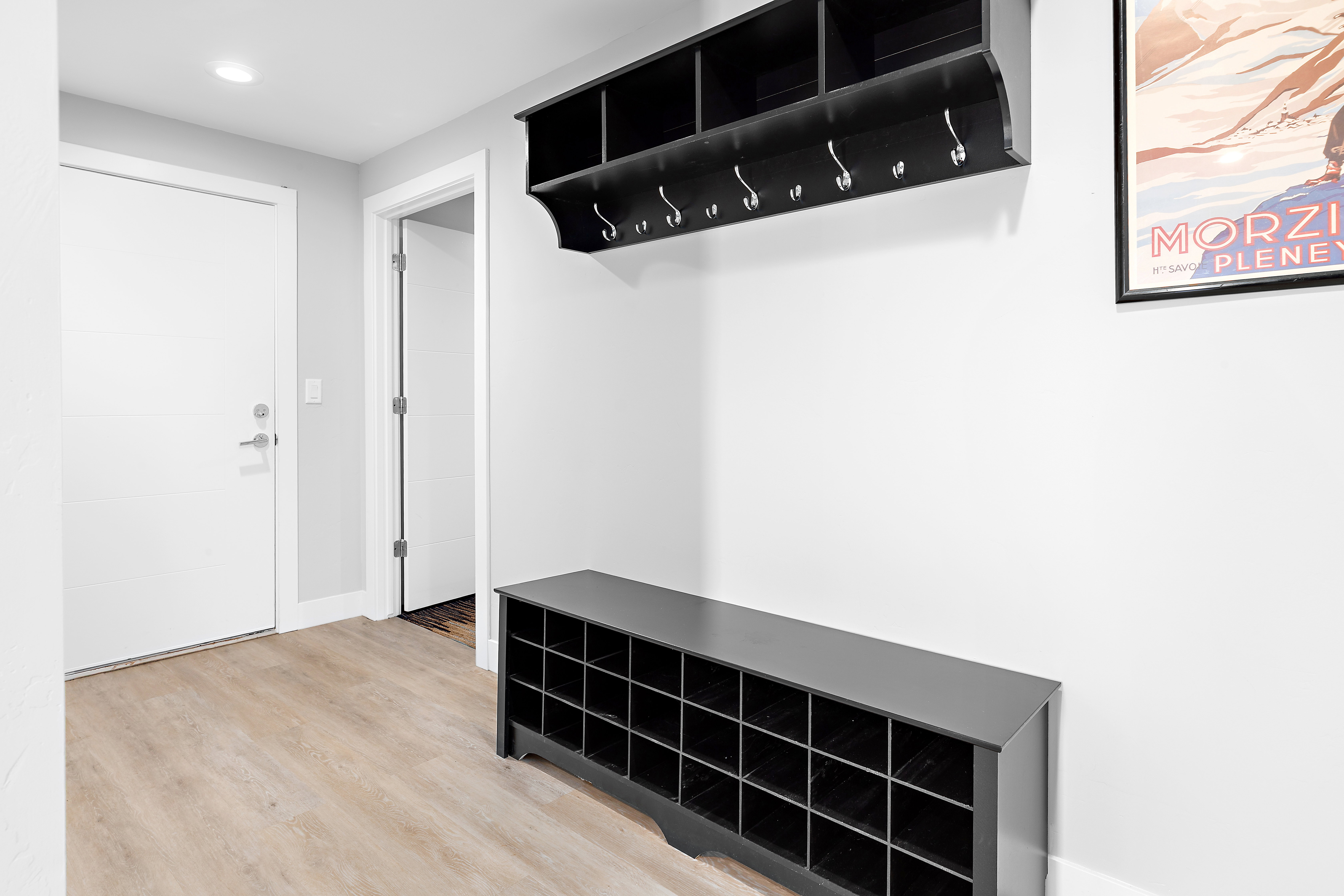 Foyer featuring light wood-finish flooring, white walls, and a recessed ceiling light