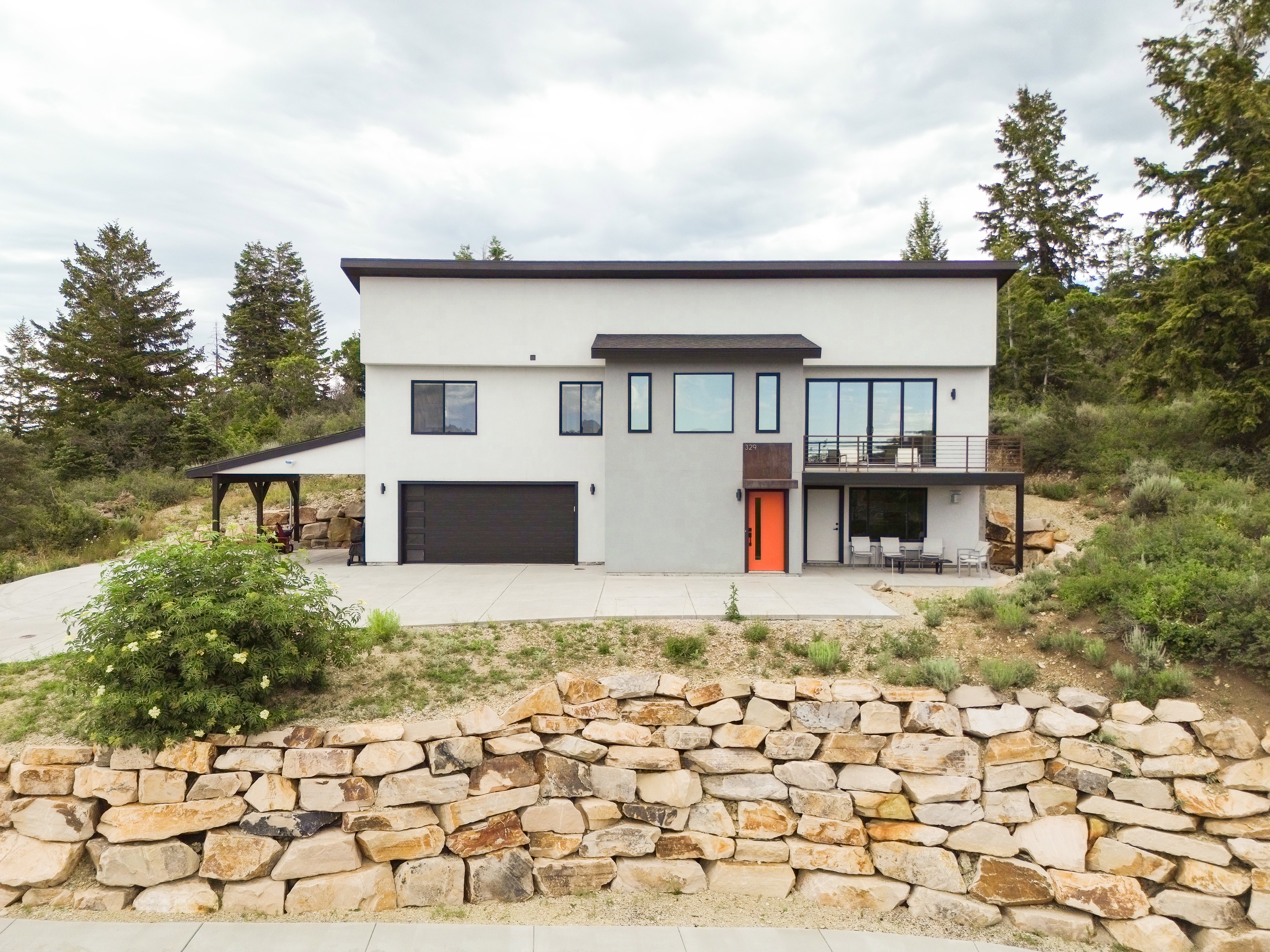 Modern two-story residence with a flat roofline and white stucco exterior