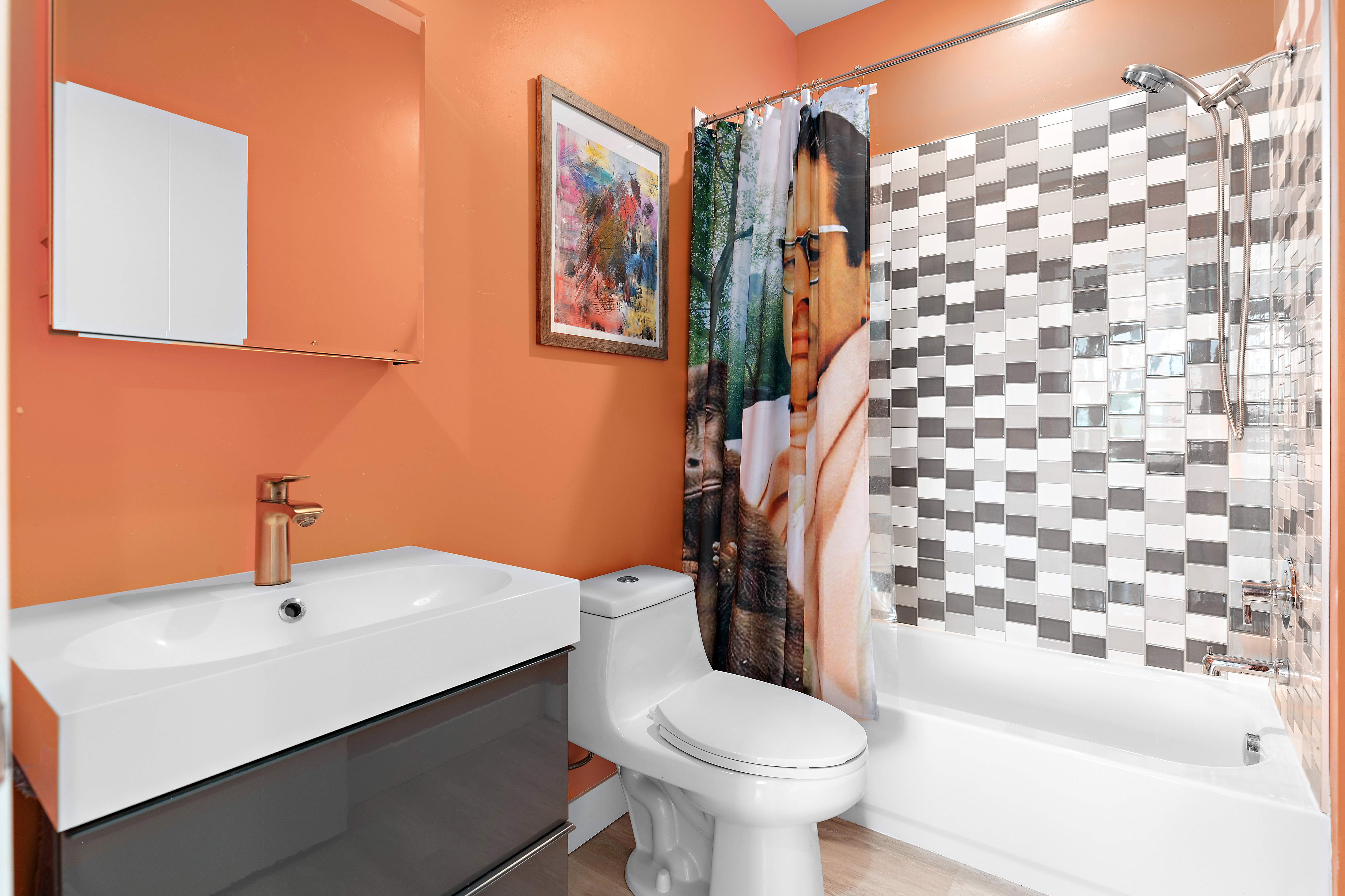 Bathroom featuring a modern vanity with a rectangular sink, a wall-mounted medicine cabinet, and a metallic-finish faucet