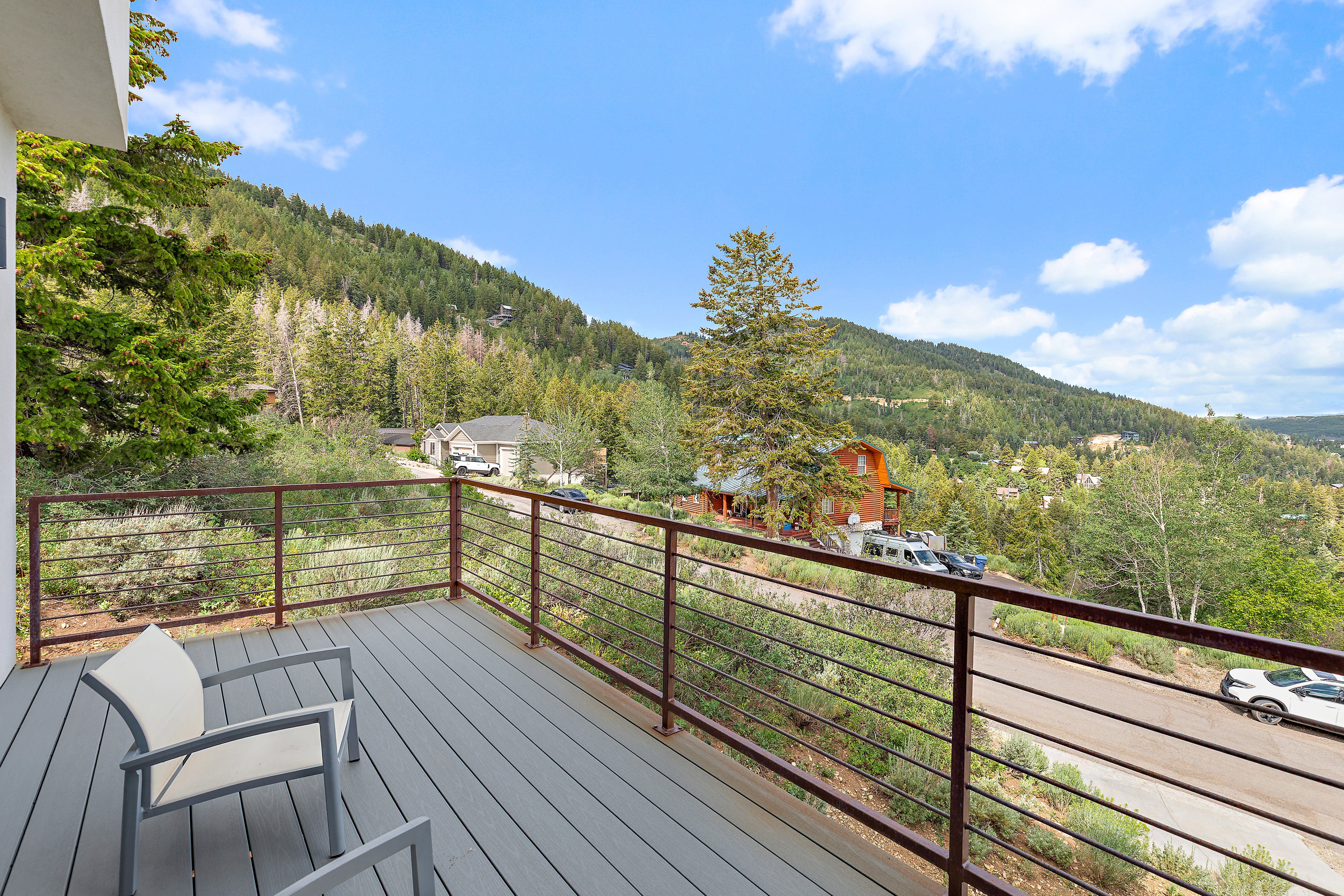 Spacious outdoor deck with composite wood-finish flooring and cable railings