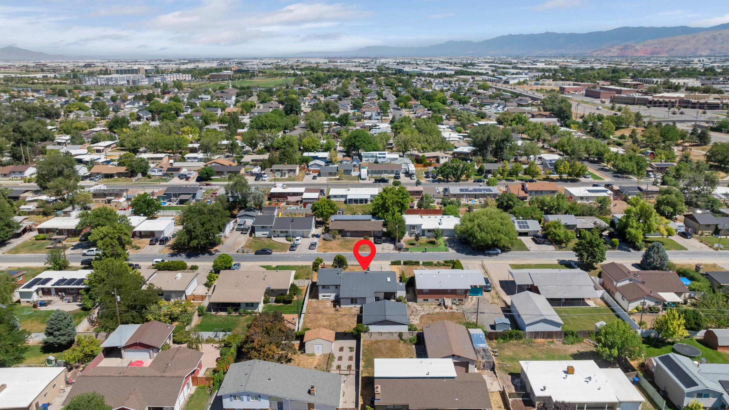 Aerial perspective showcasing a residential neighborhood with distant mountain ranges