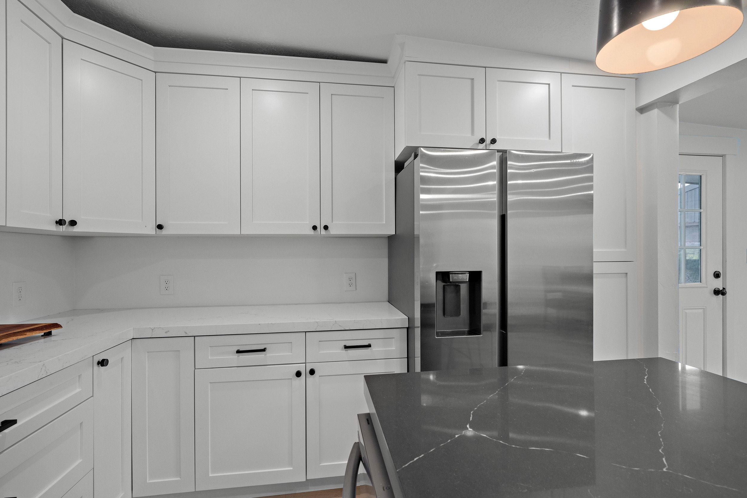 Contemporary kitchen with white shaker-style cabinetry