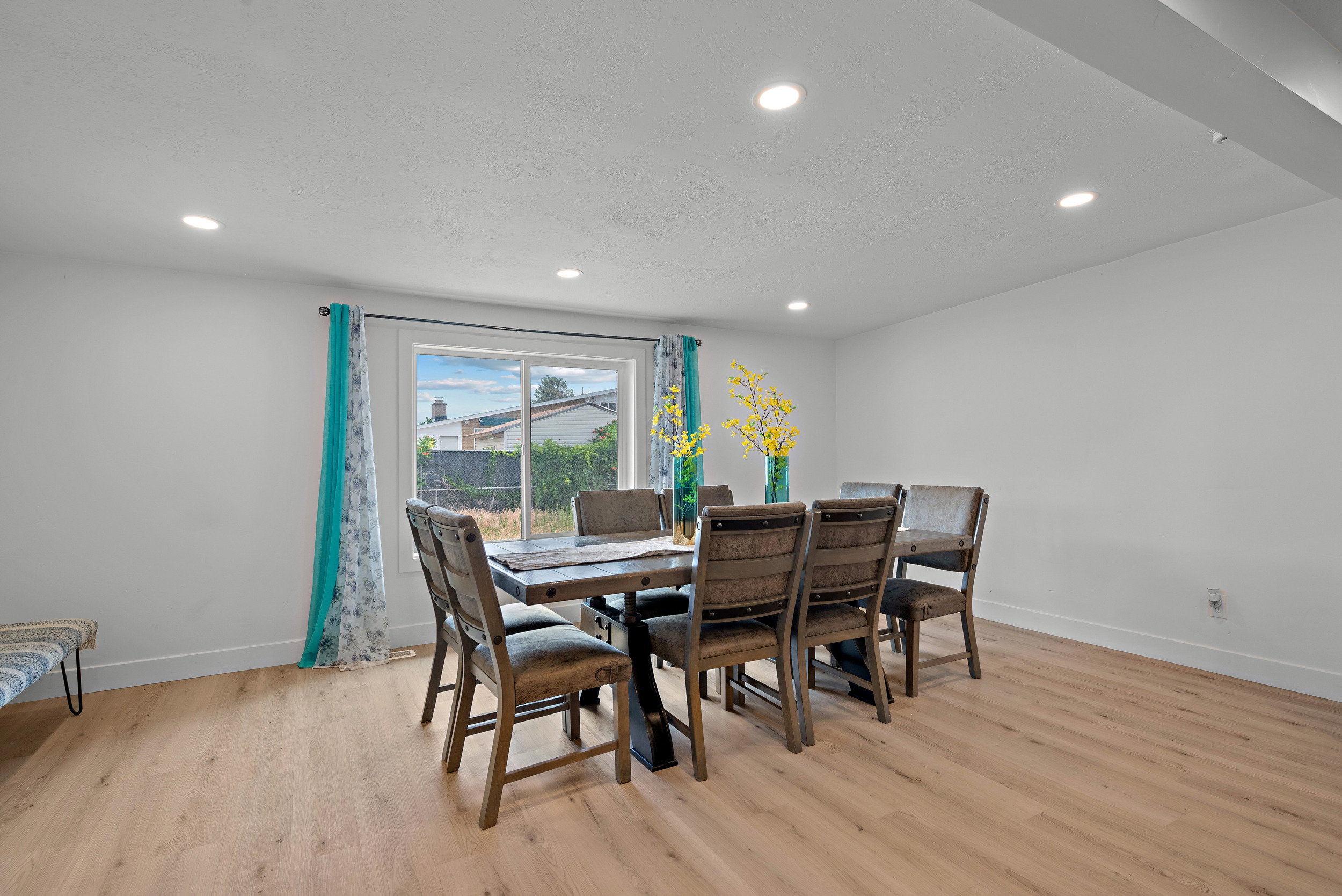 Bright interior space featuring light wood-finish flooring, recessed lighting, and a large window