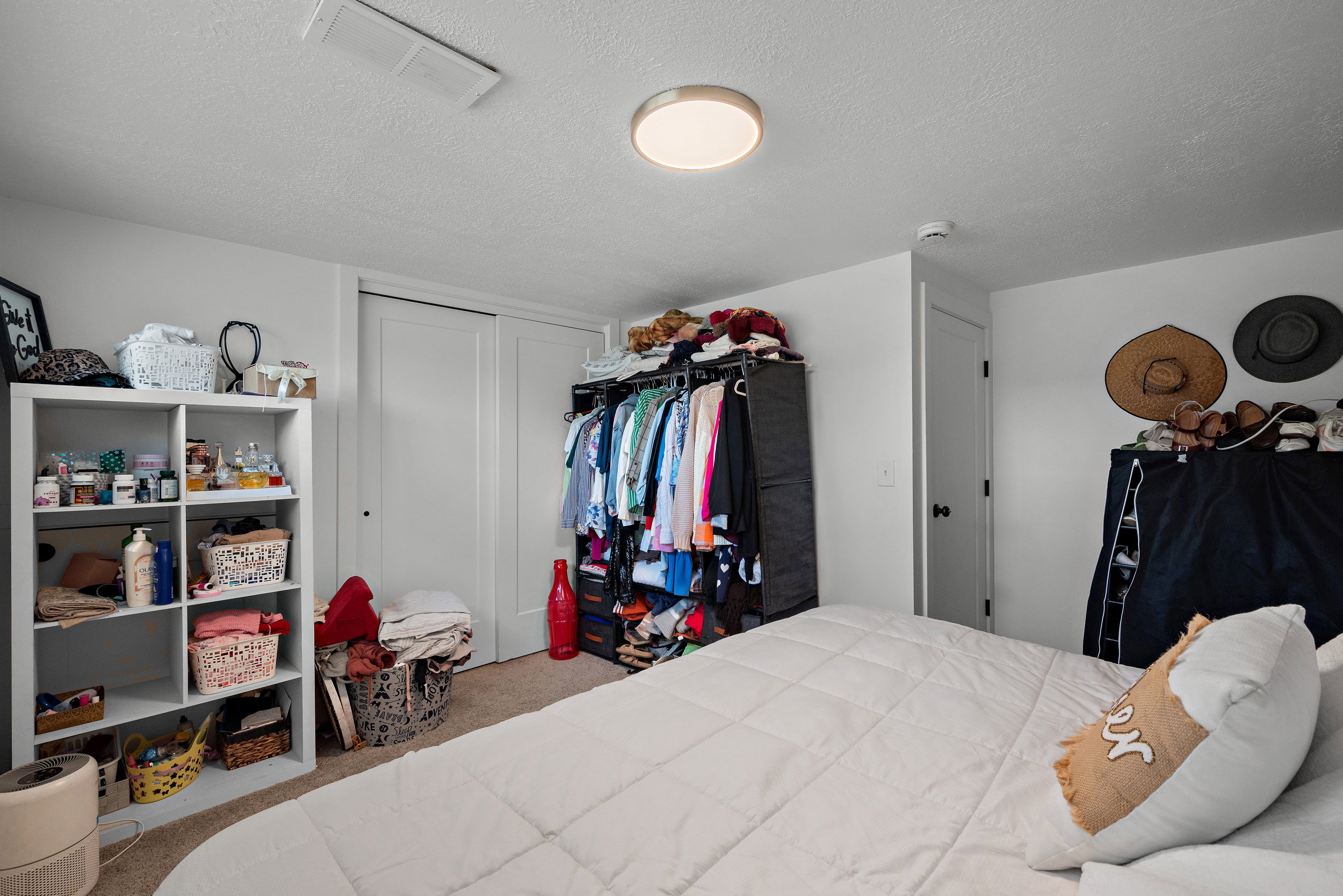 White walls with a textured ceiling and recessed lighting create a bright atmosphere