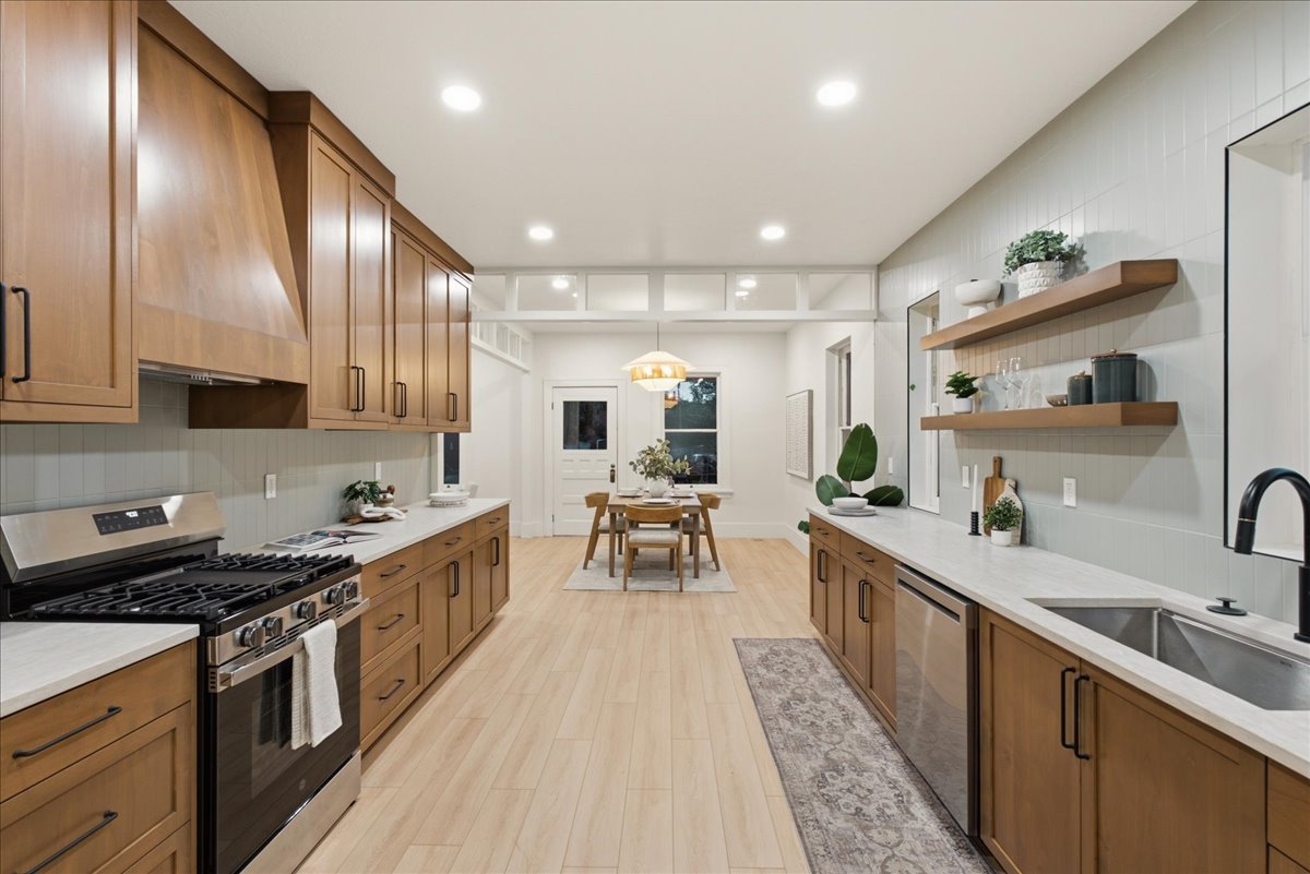 Open-concept kitchen with wood-finish flooring and recessed lighting