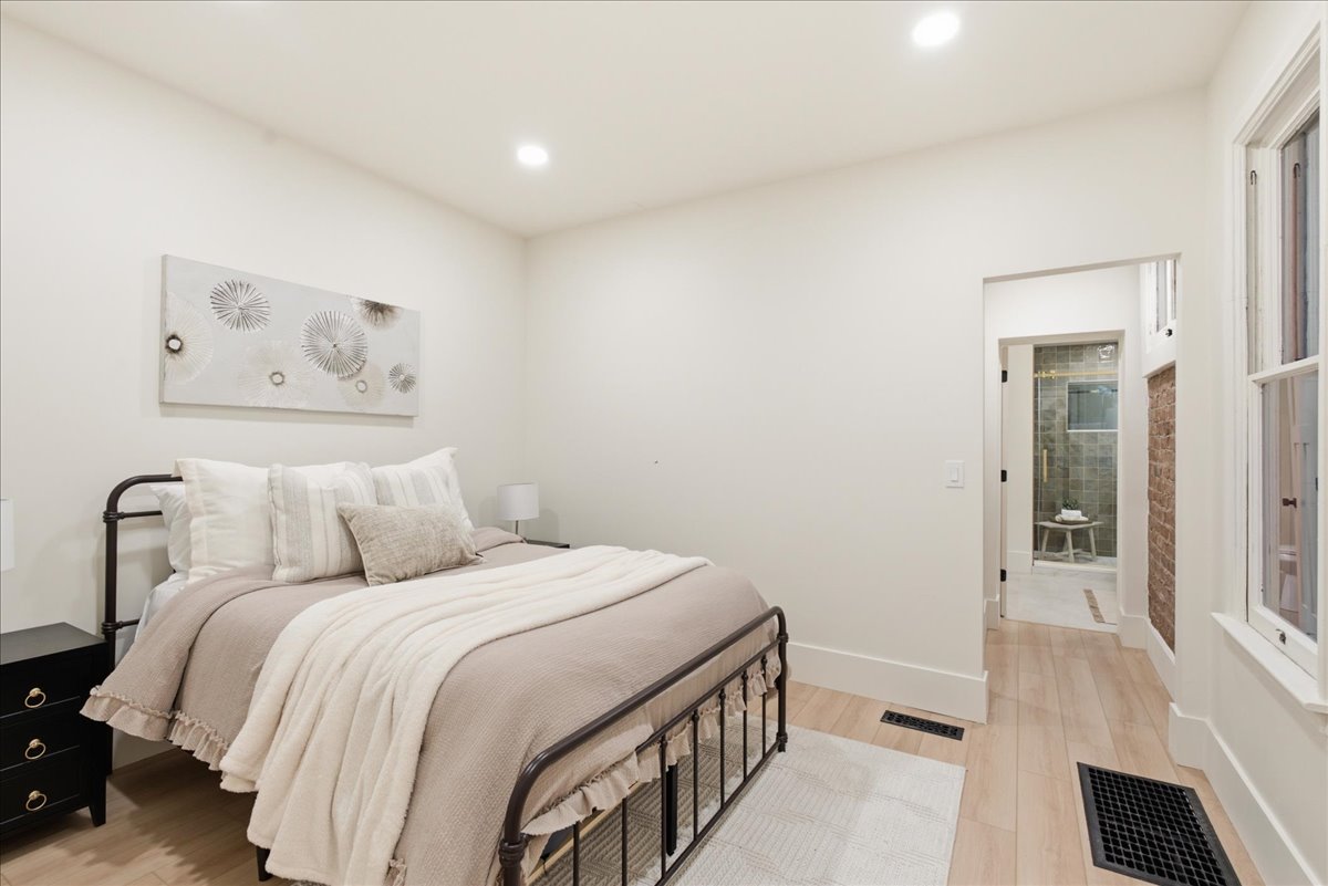 Light wood-finish flooring with white baseboards throughout