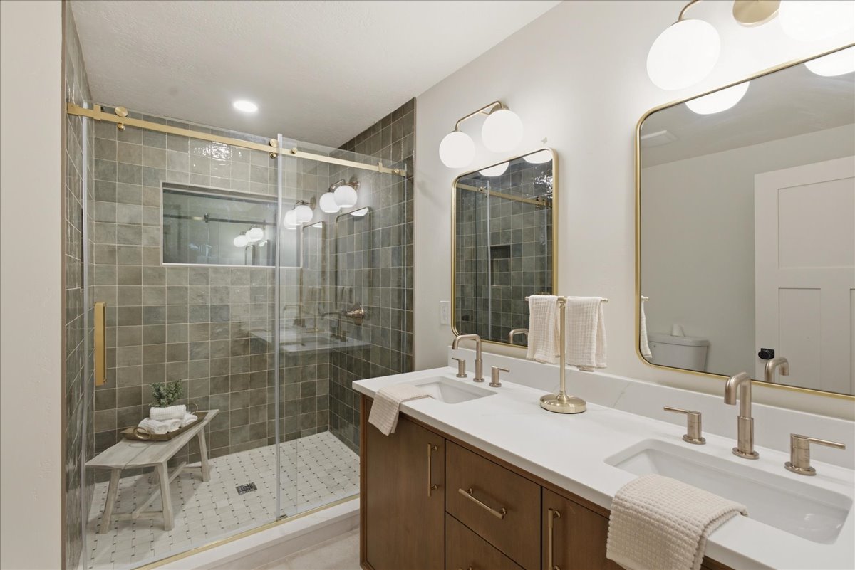 Bathroom featuring a dual vanity with undermount sinks and wall-mounted mirrors
