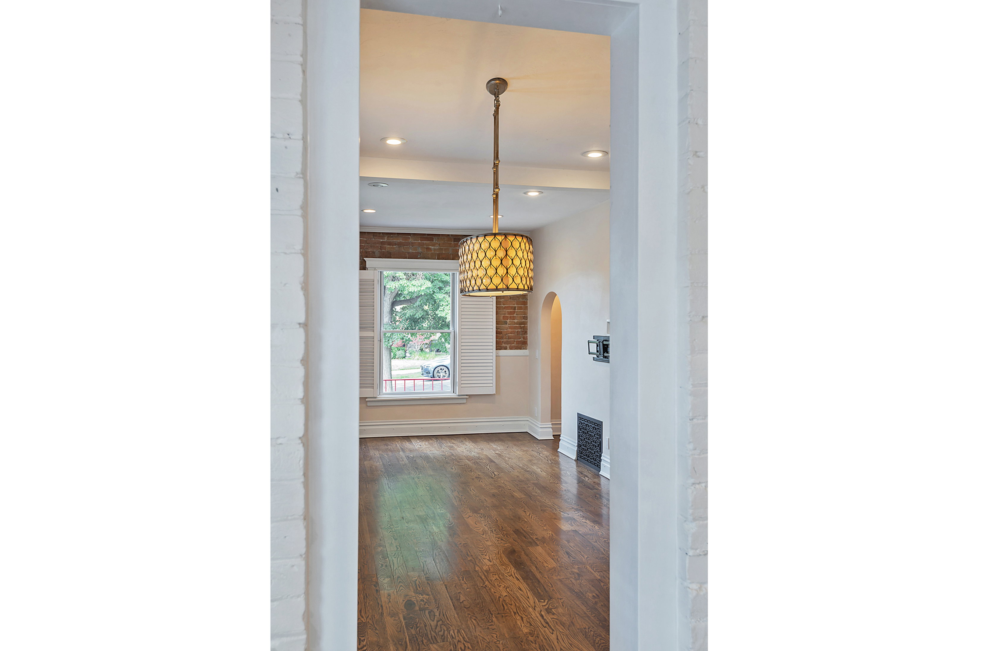 Hardwood flooring extending through a brightly lit interior