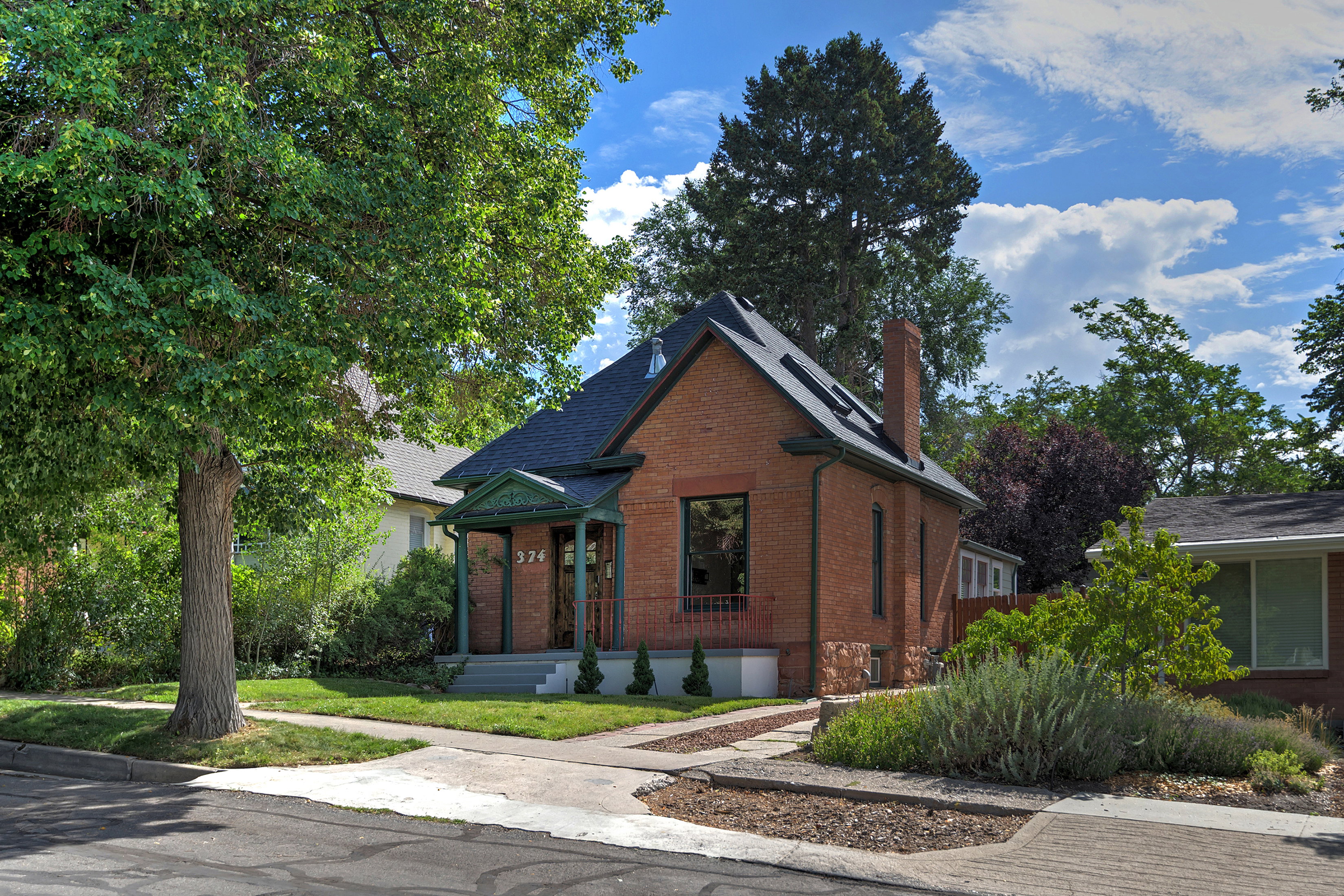 Brick exterior with a dark roof and prominent chimney