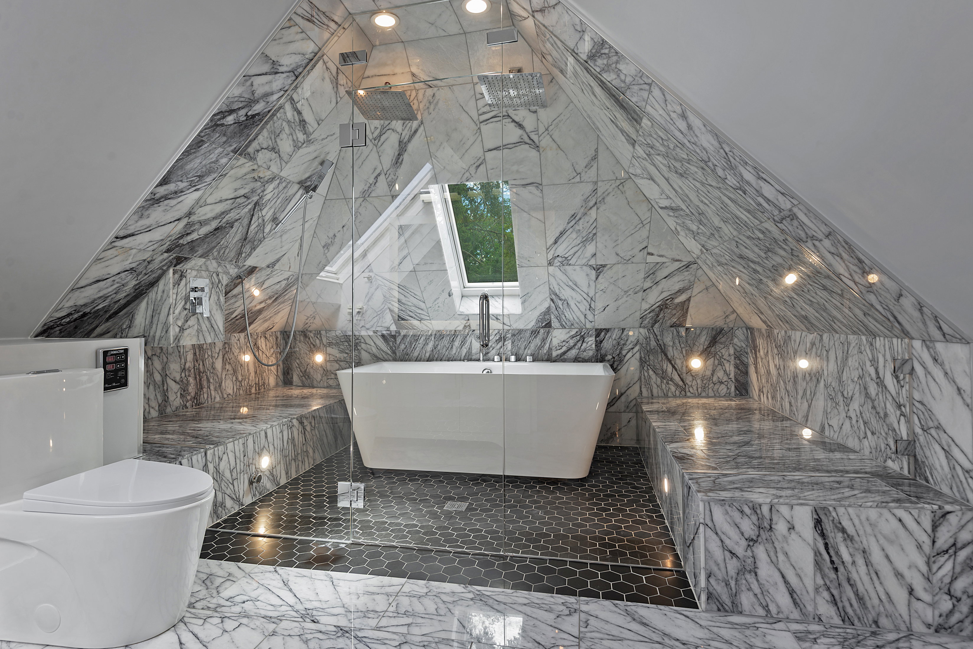 Attic bathroom with full marble tile walls and integrated built-in benches