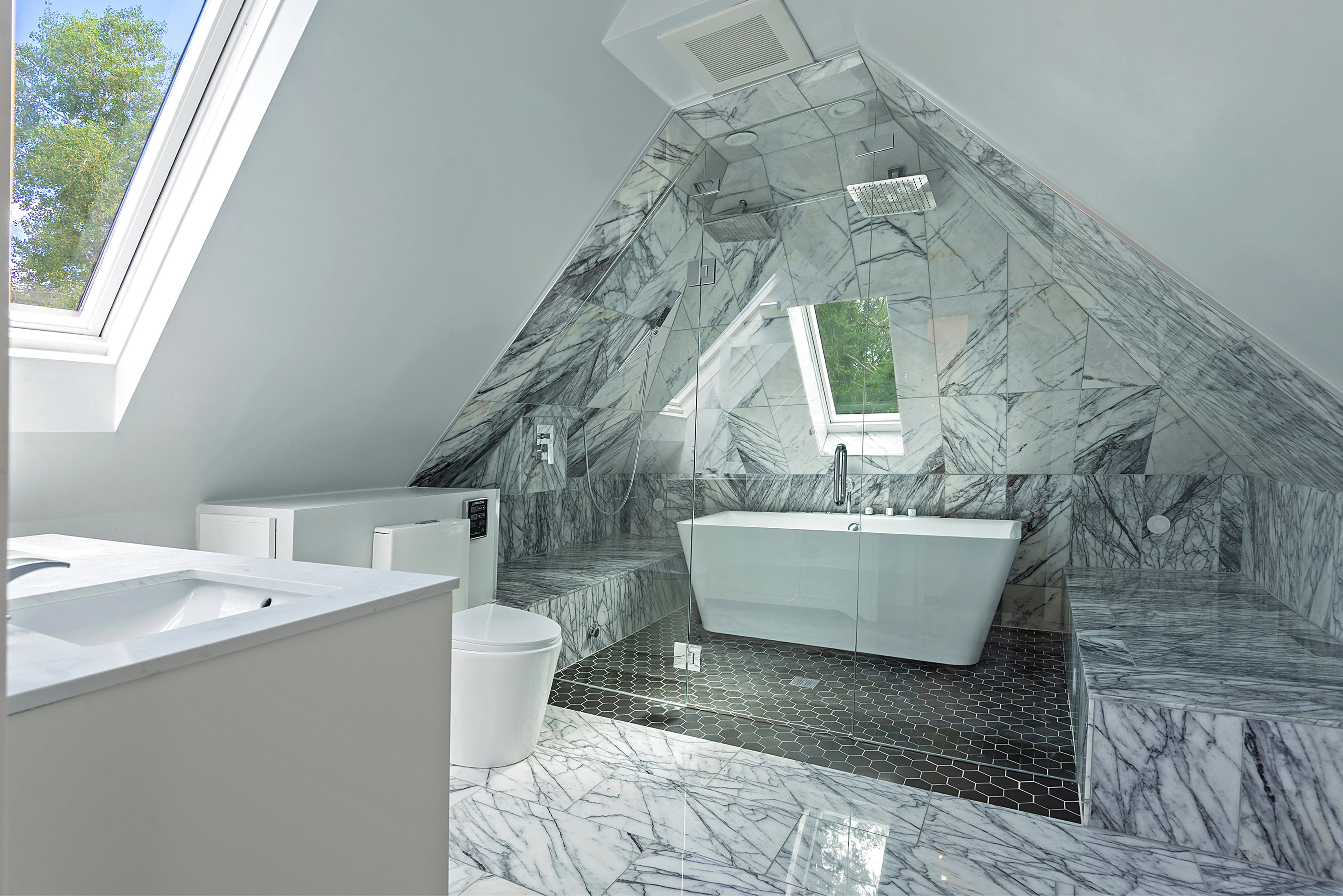 Contemporary bathroom with sloped ceilings and skylights