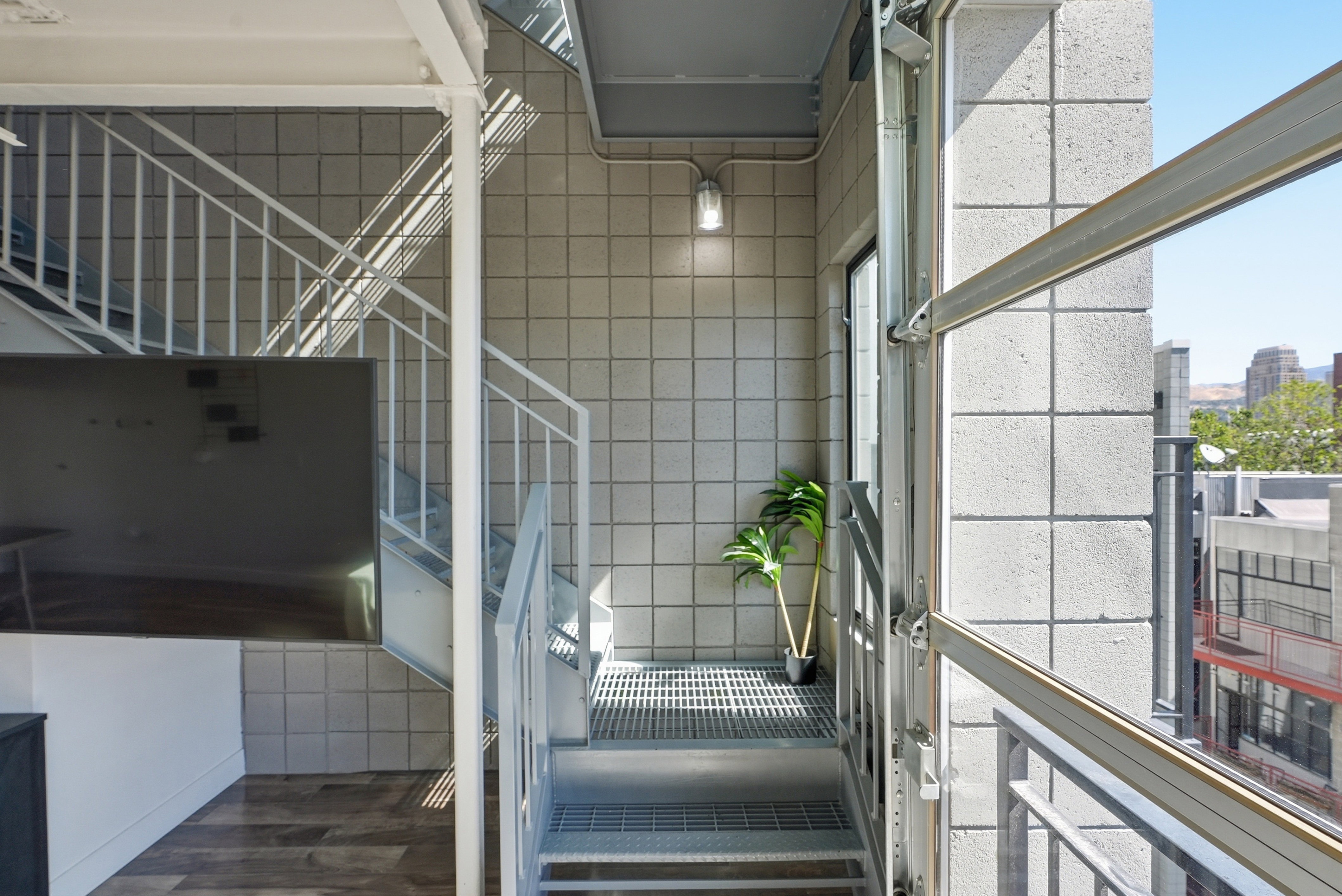 Industrial-style staircase with metal railings and perforated treads