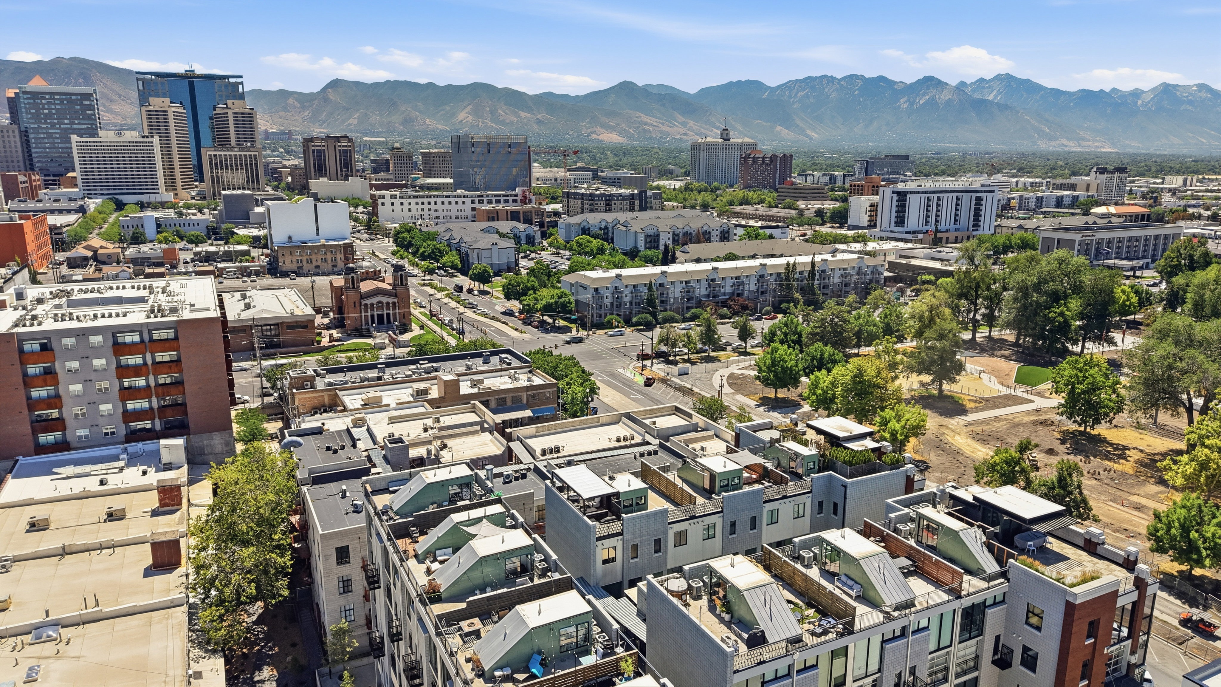 Rooftop patio with cityscape and mountain backdrop