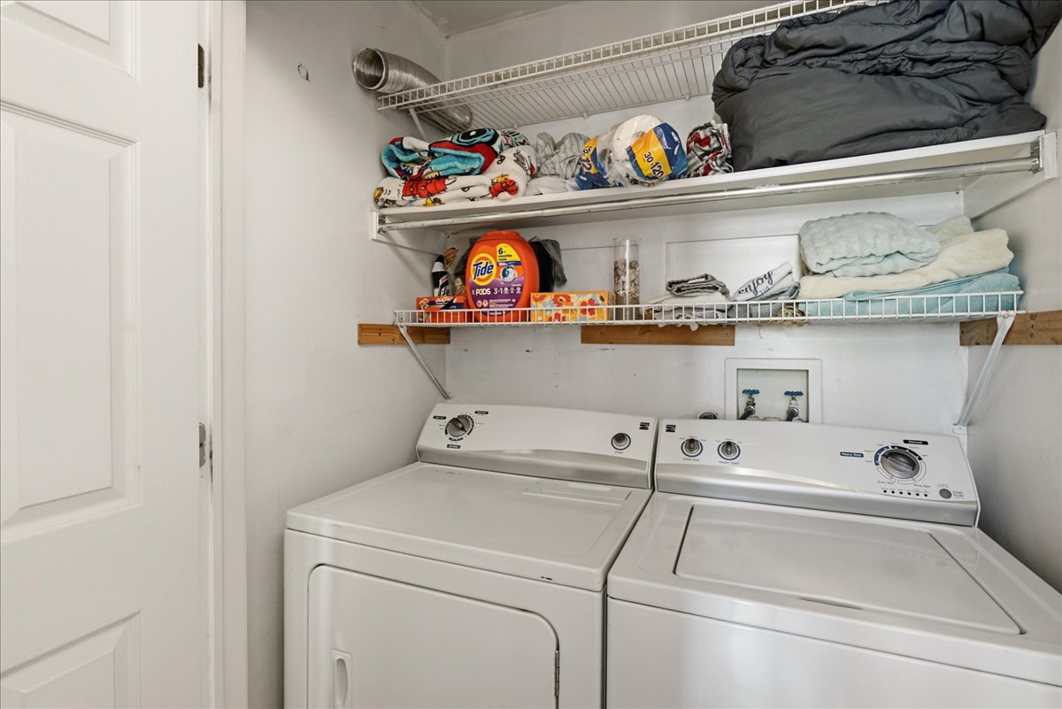 Dedicated laundry area featuring white wire shelving