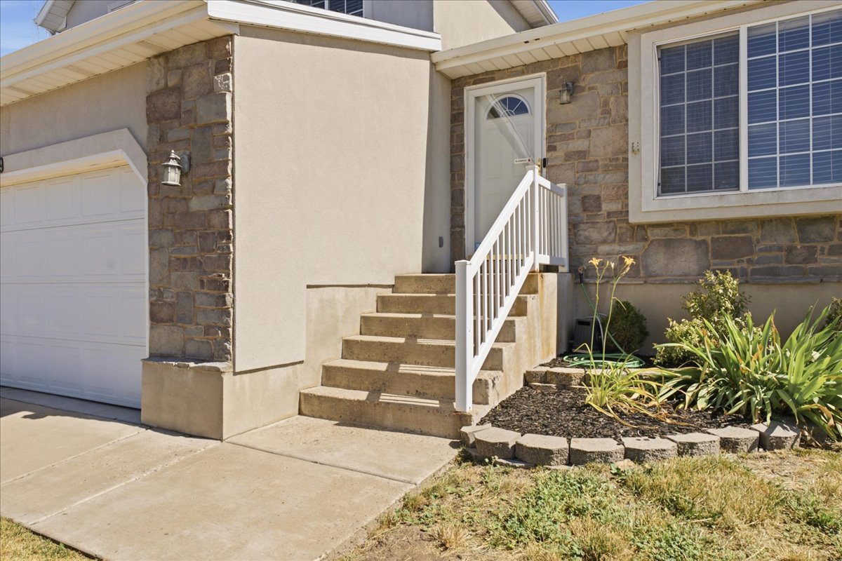 Exterior featuring stone veneer and stucco finishes