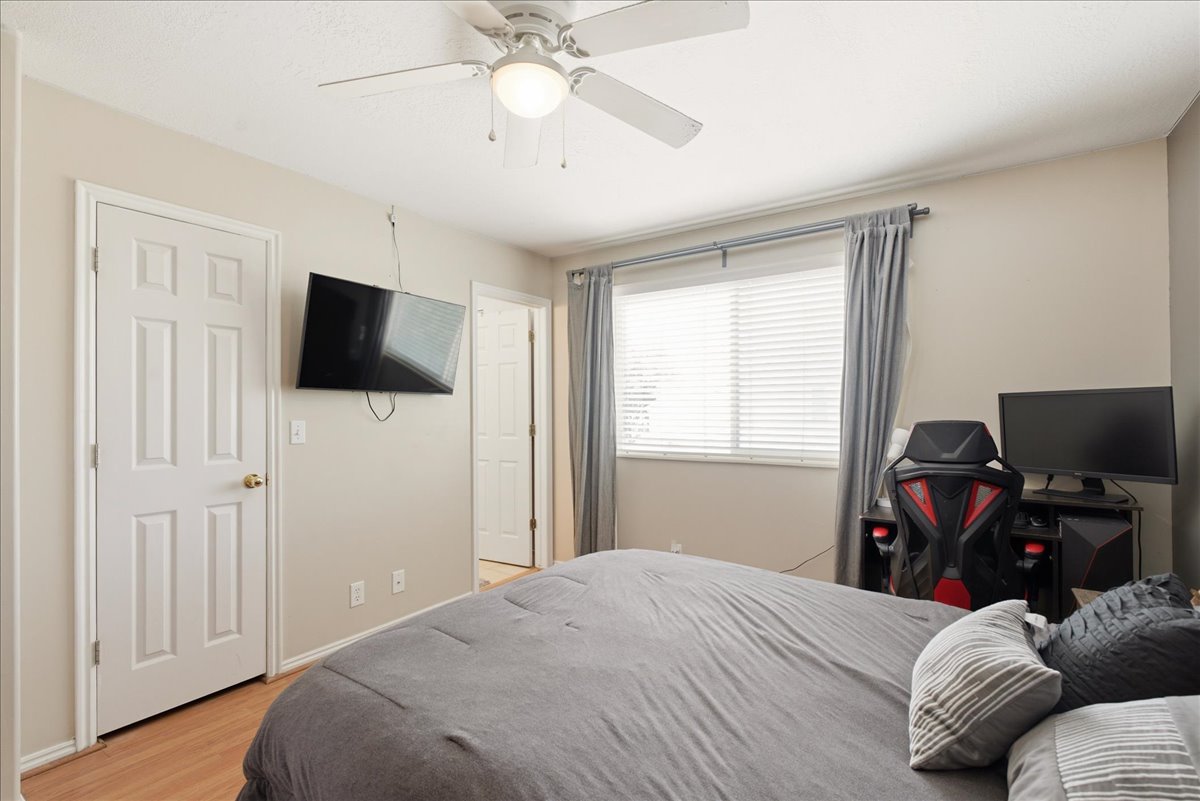 Room featuring light wood-finish flooring and a ceiling fan with integrated lighting