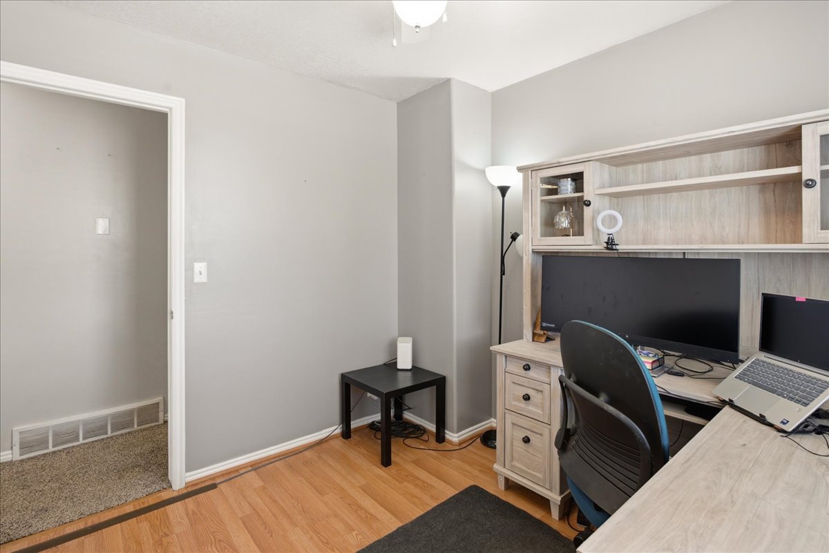 Room featuring light wood-finish flooring, light gray wall paint, and white trim