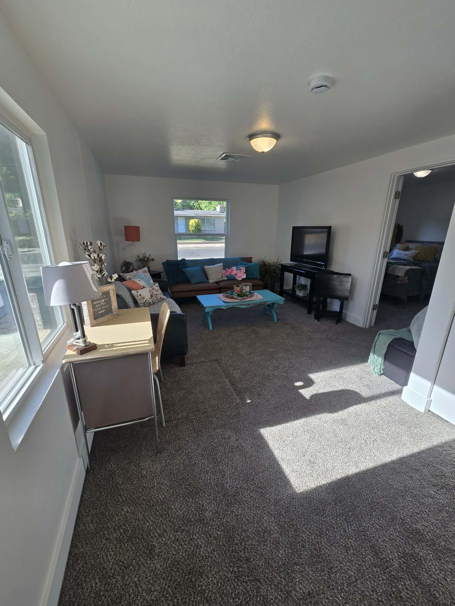 Spacious interior featuring neutral carpeting and white walls
