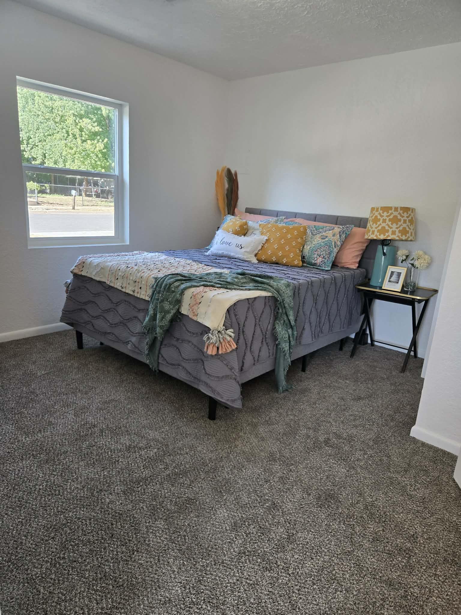 Plush grey carpeting complements bright white walls