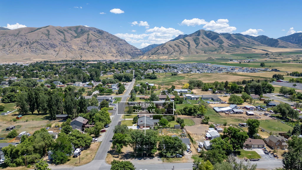 Expansive aerial panorama showcasing a residential area with varied housing styles and abundant mature trees