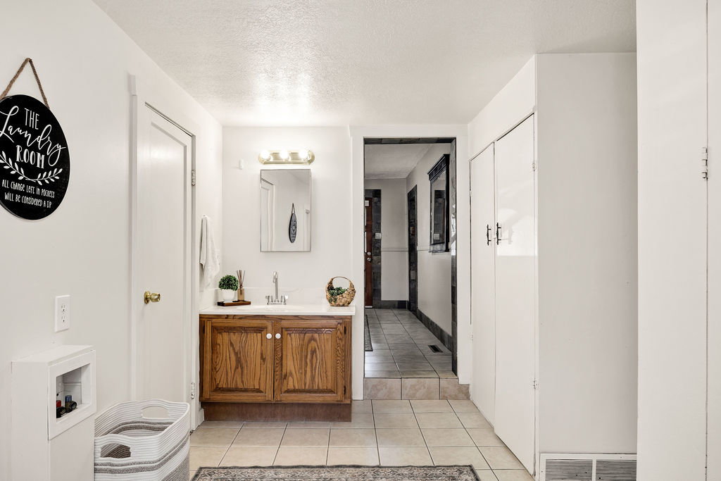 Oak-finish vanity with white countertop and integrated sink