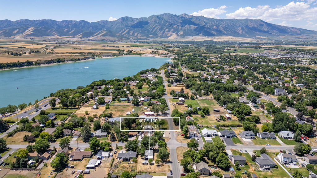 Aerial perspective showcasing a residential area with a prominent body of water and distant mountains