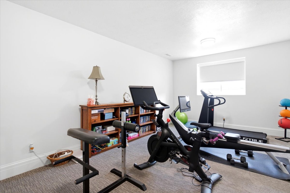 Dedicated room featuring light gray carpet flooring and white painted walls