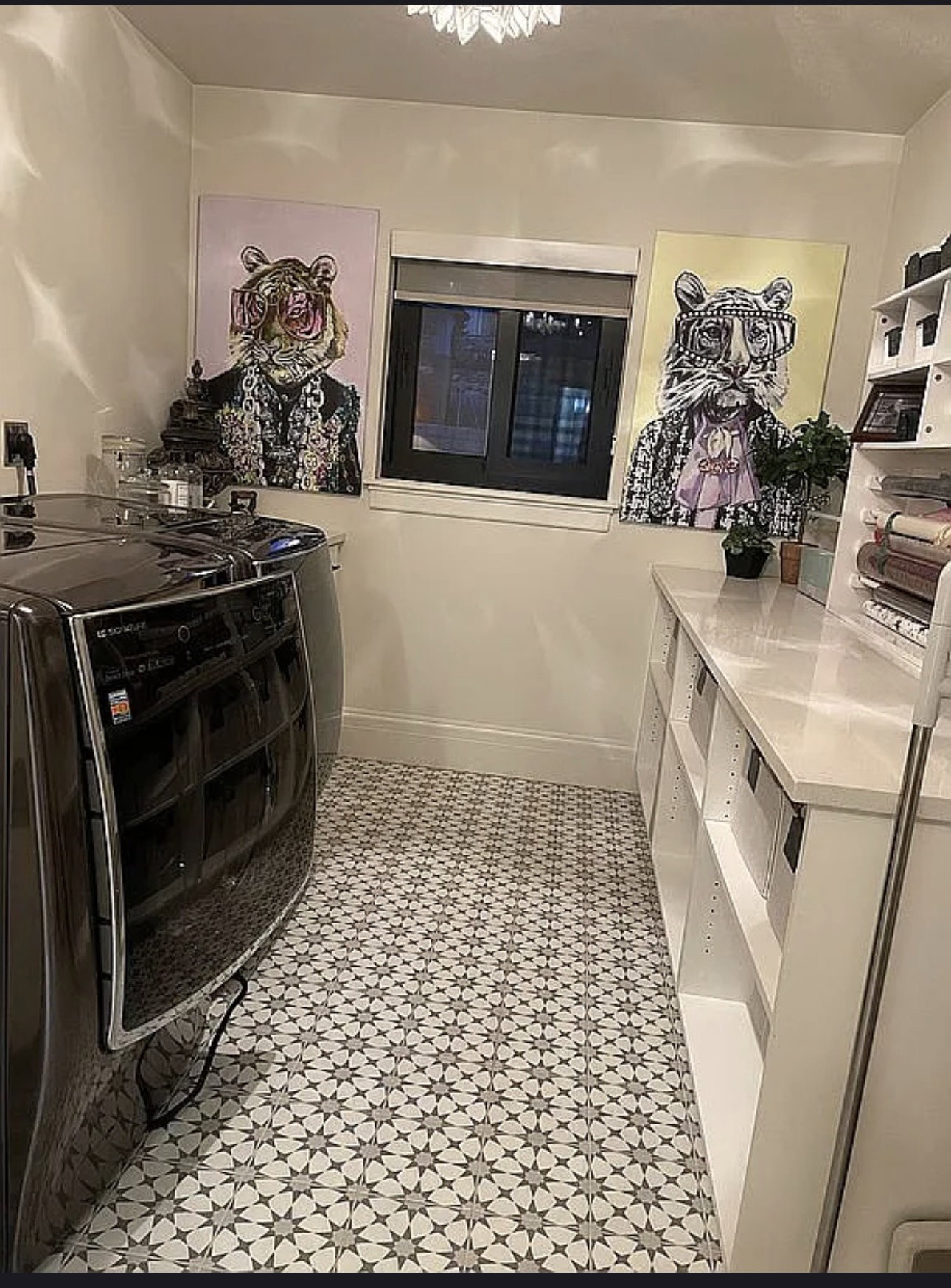 Laundry room featuring patterned tile flooring, a window with blinds, and white built-in shelving with a countertop