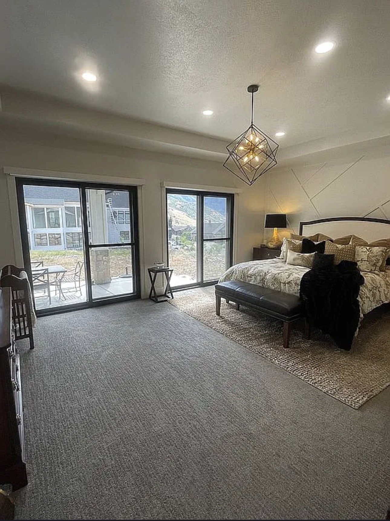 Expansive room featuring wall-to-wall carpeting and a geometric chandelier