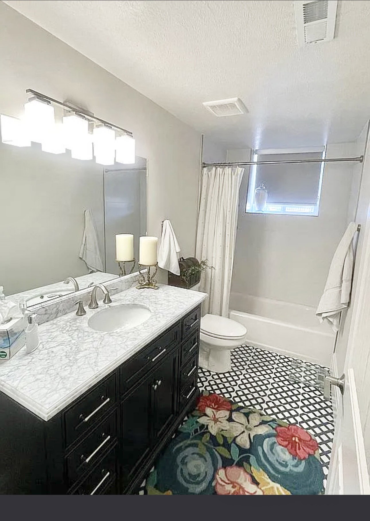 Bathroom featuring a dark wood vanity with a white countertop and an undermount sink