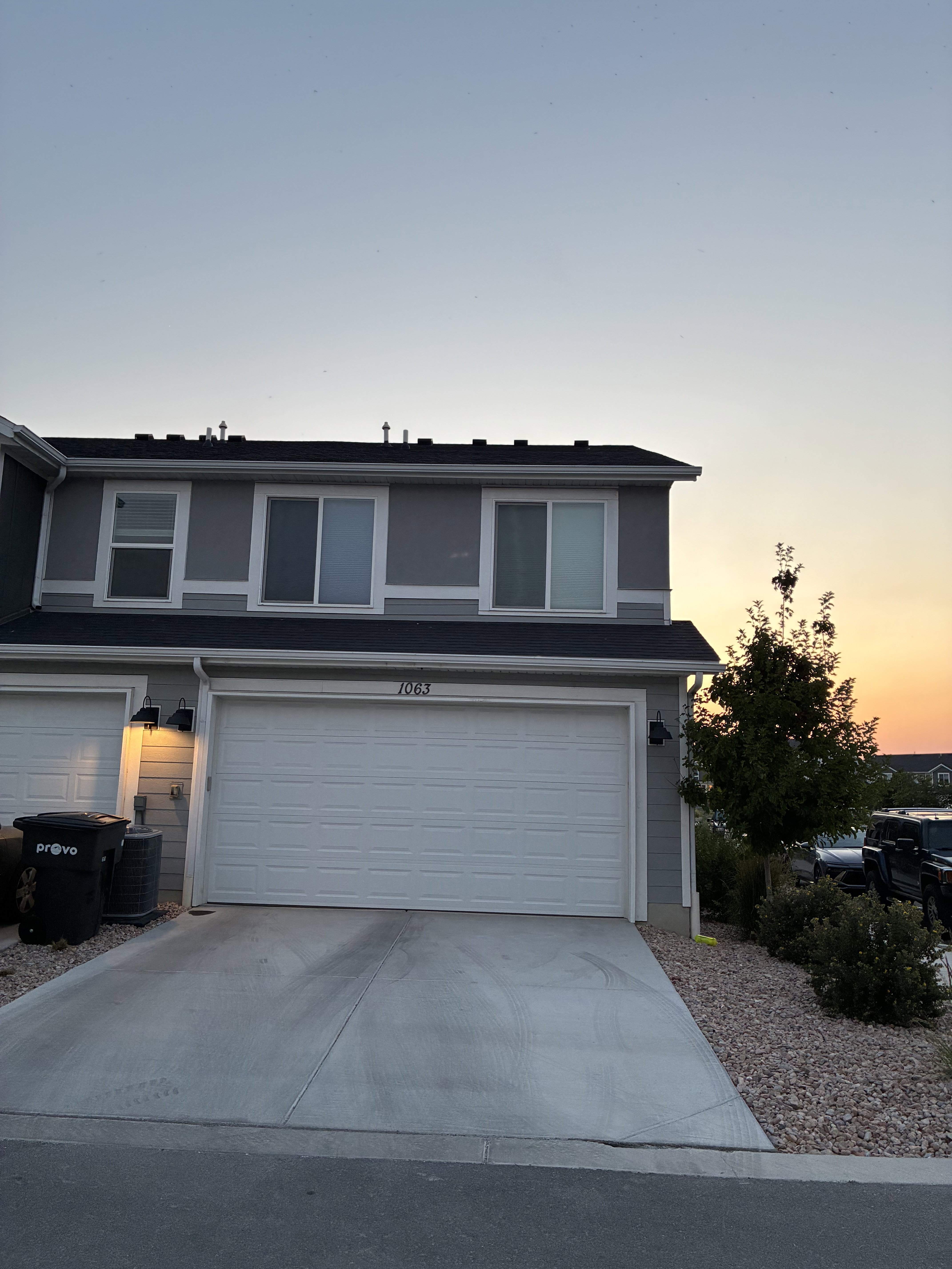 Two-story residence featuring a two-car garage with a concrete driveway