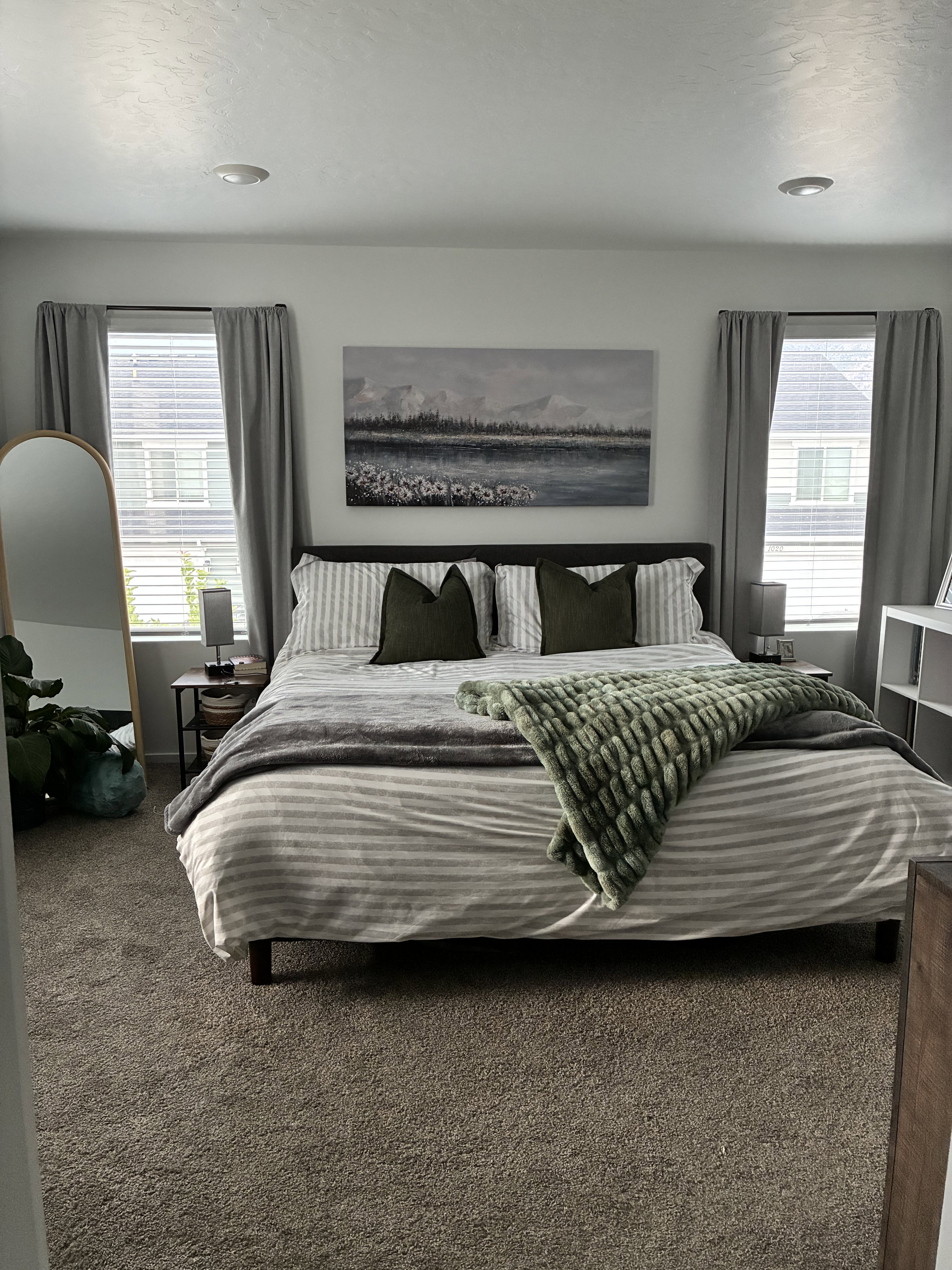 Spacious bedroom featuring neutral carpet, recessed lighting, and two windows with blinds