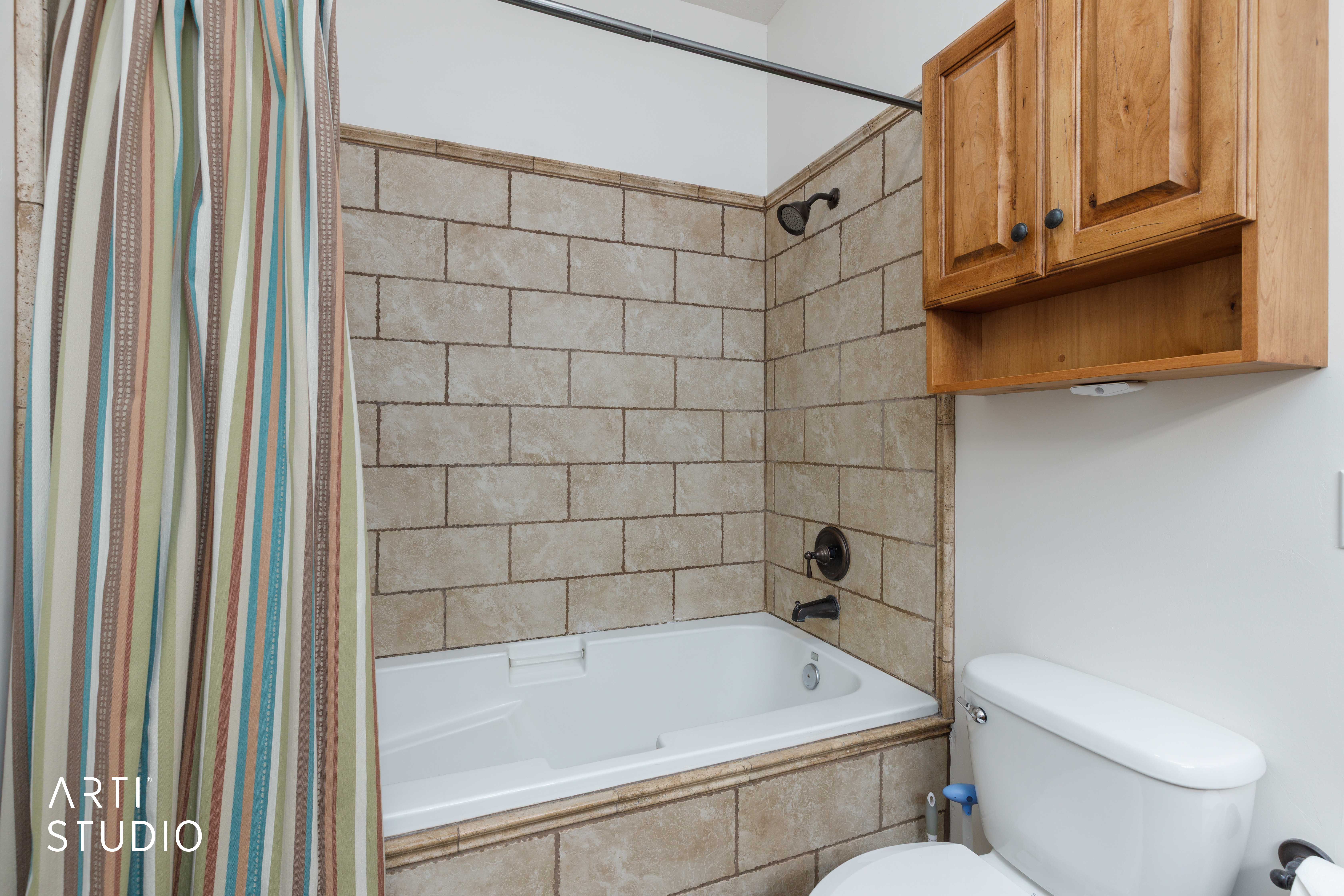 Tiled shower featuring large deep bathtub