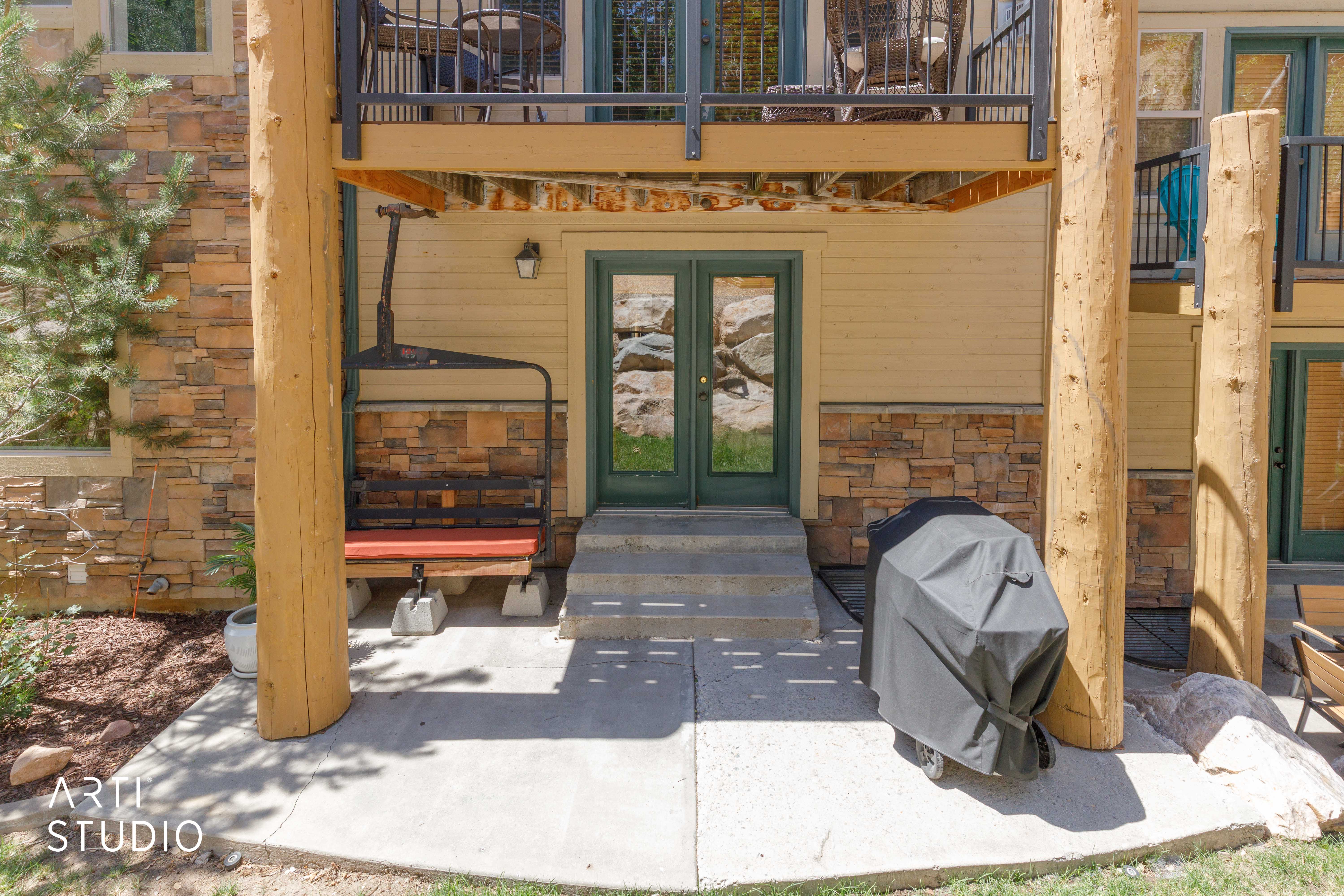 Back patio area featuring Iconic Timberline lift chair with cushion and Weber grill