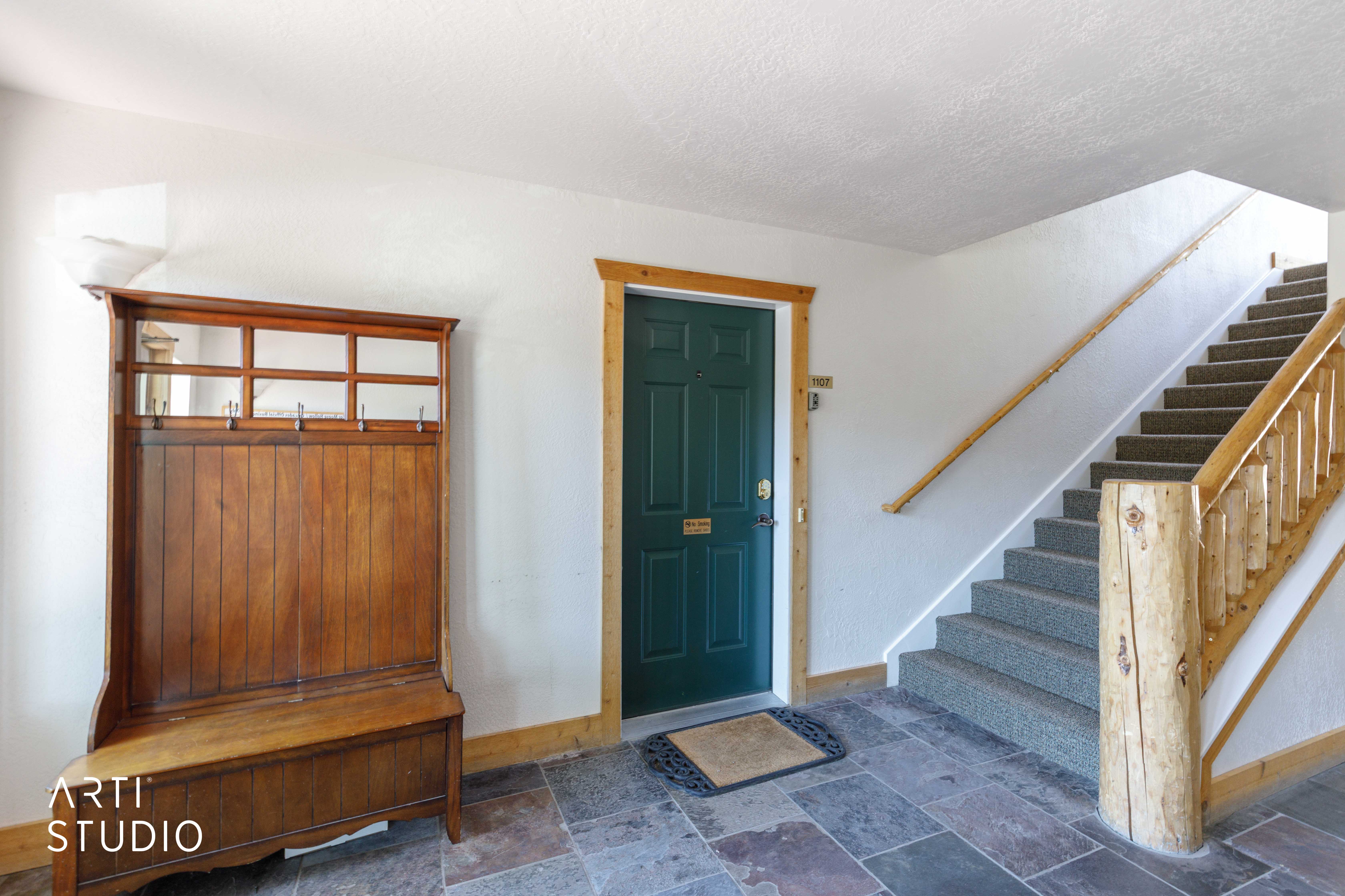 Entry foyer with slate tile flooring and white walls