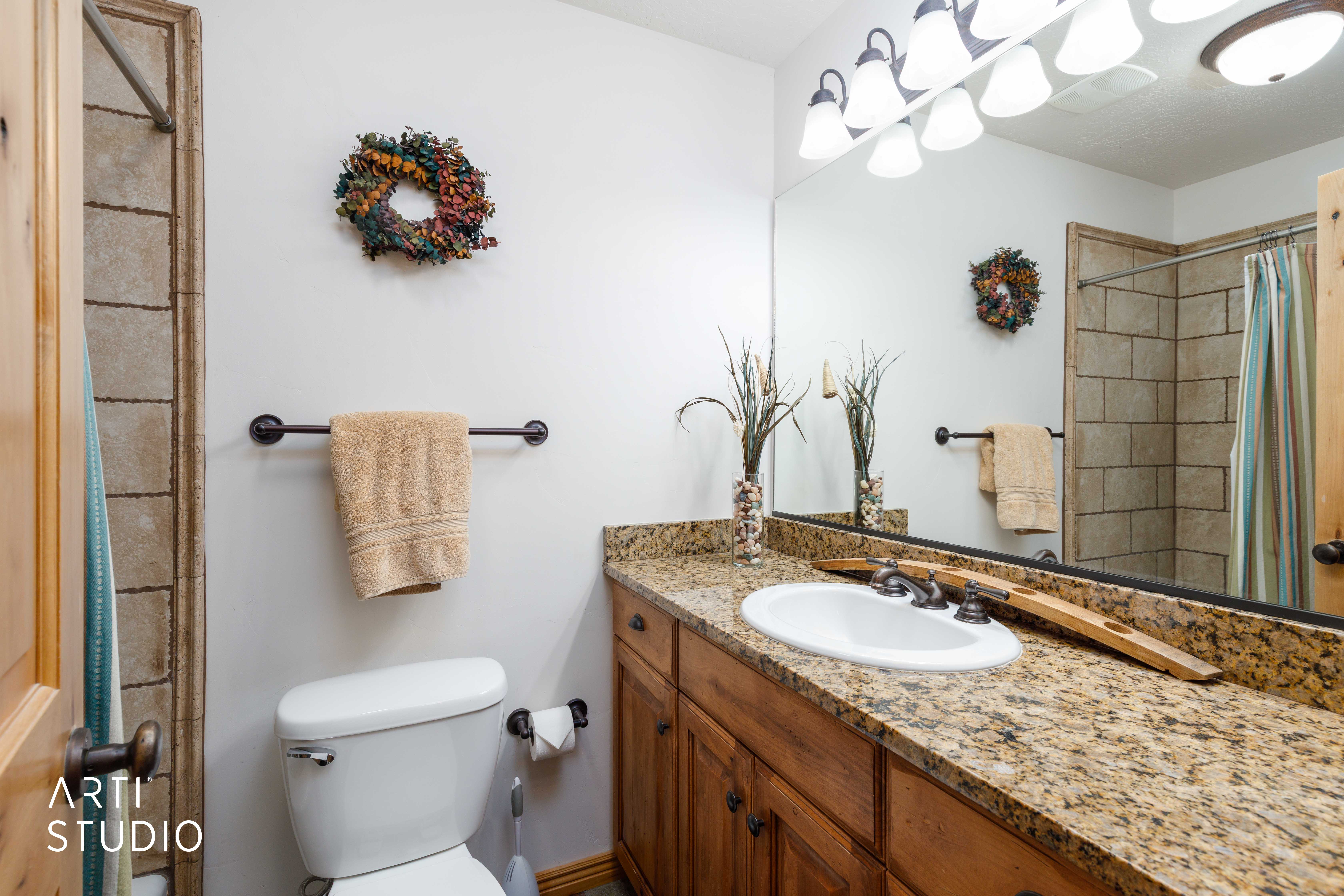 Bathroom featuring a vanity with a granite countertop, and full tob/shower combo.