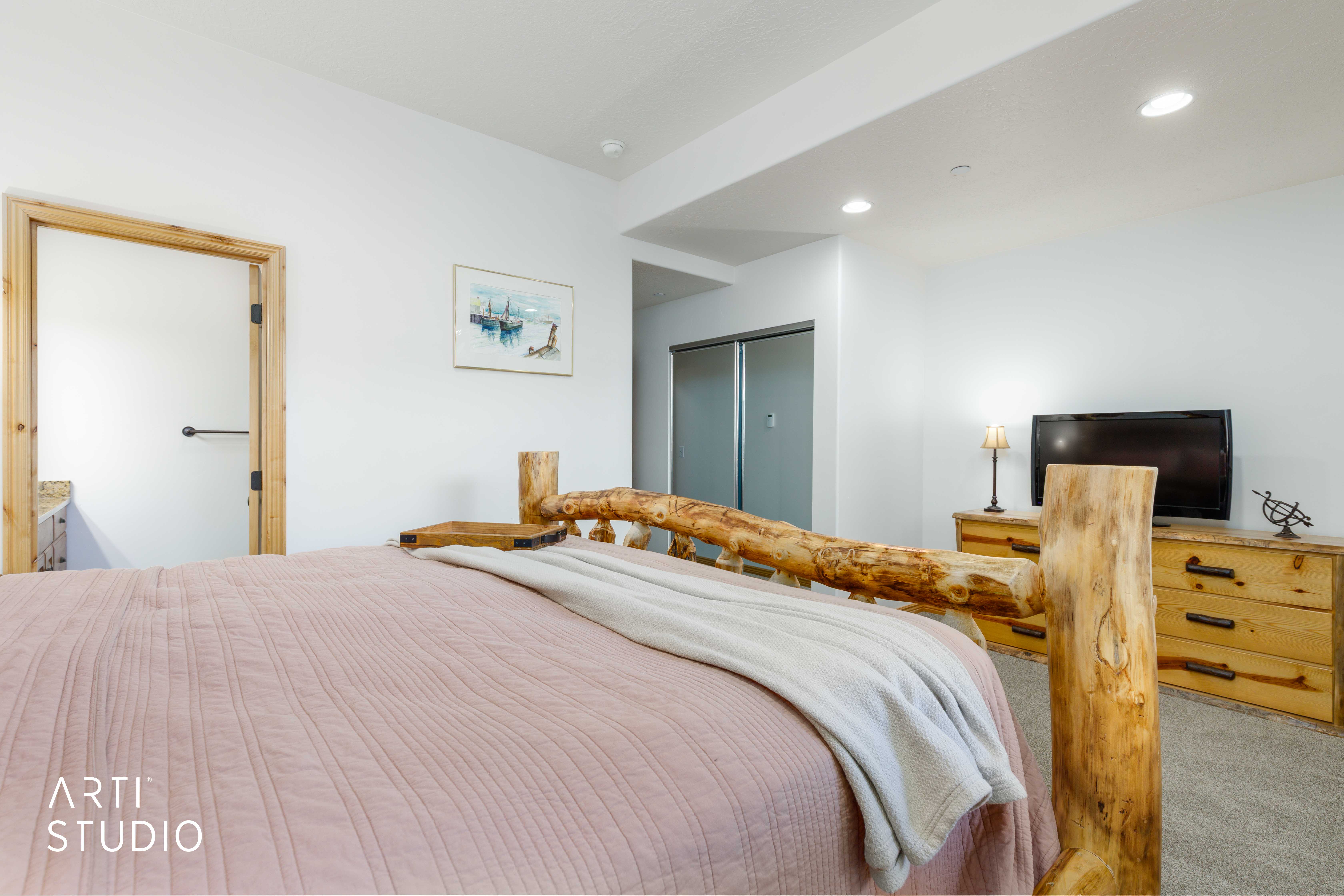 Carpeted room featuring a natural wood-finish door frame, recessed lighting, and a sliding glass door